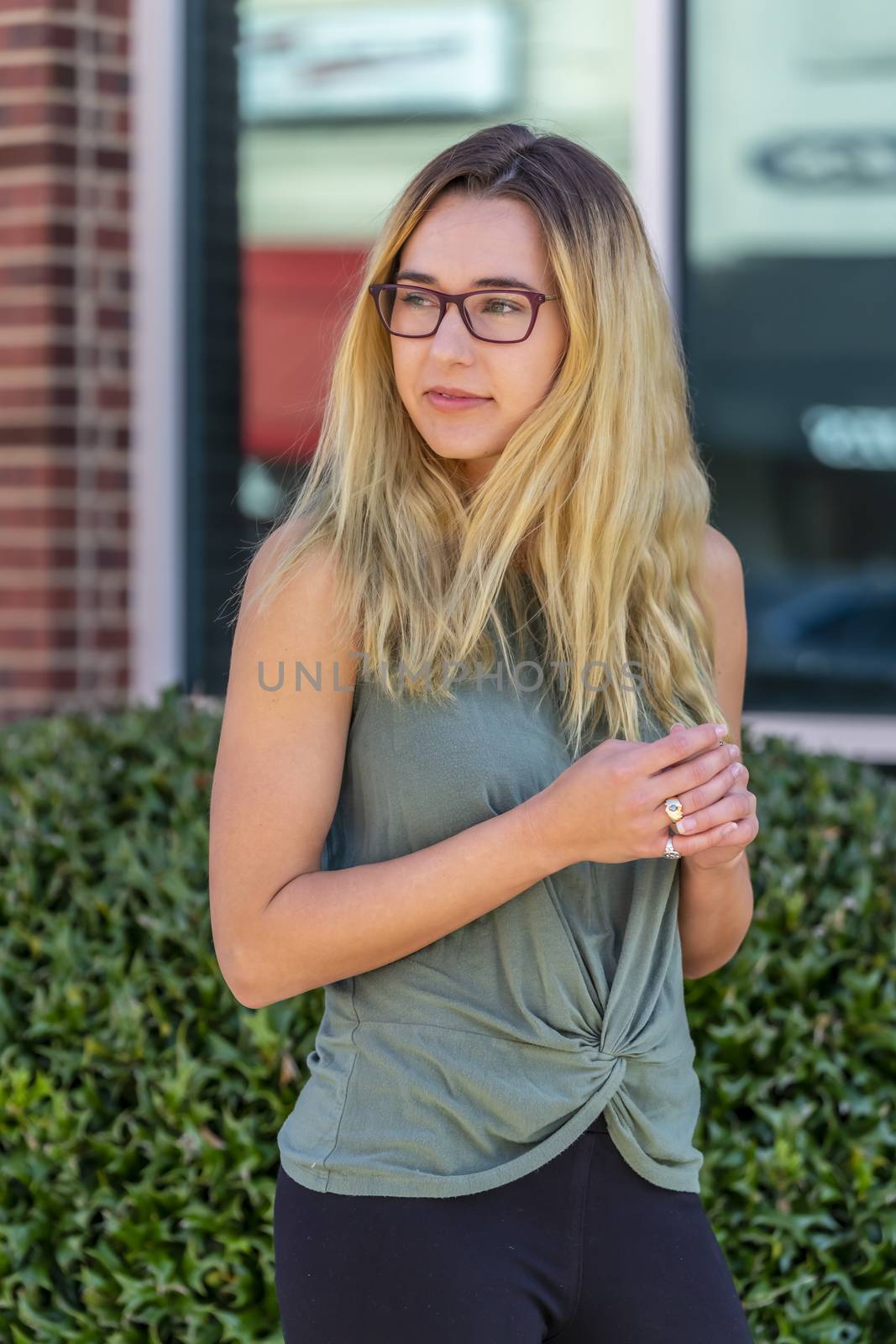 A gorgeous blonde model enjoys a summers day outdoors in a small town