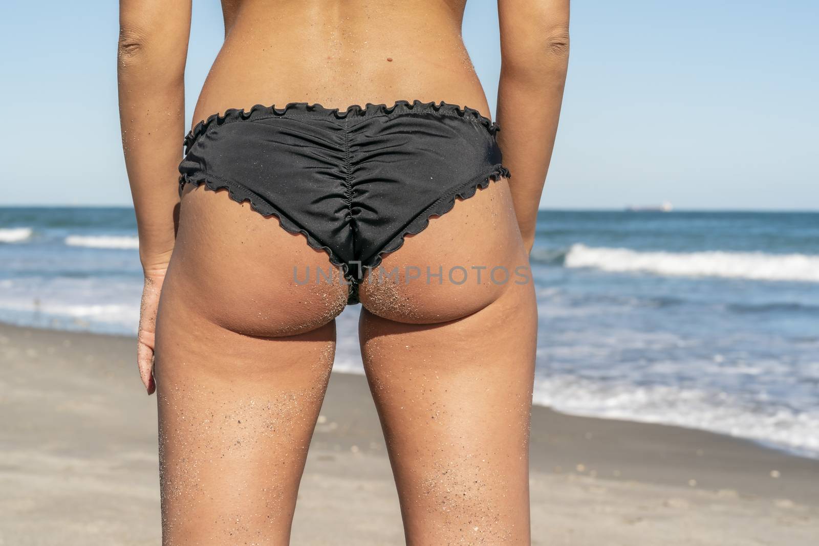A gorgeous bikini model posing in a beach environment