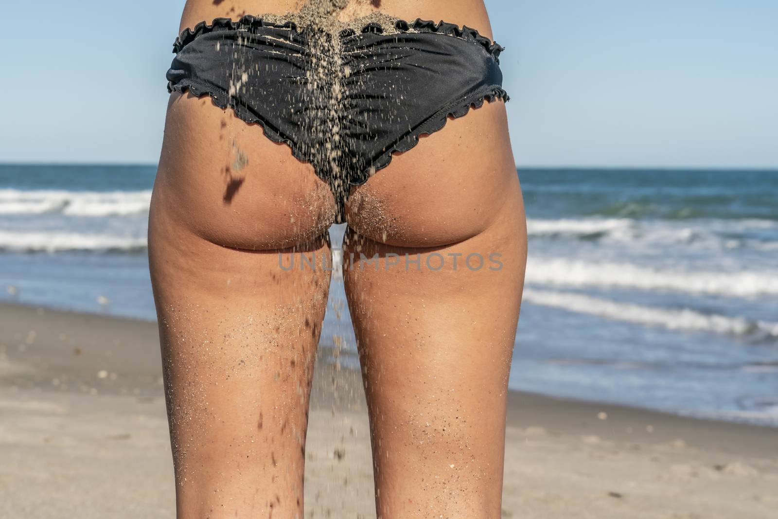 A gorgeous bikini model posing in a beach environment