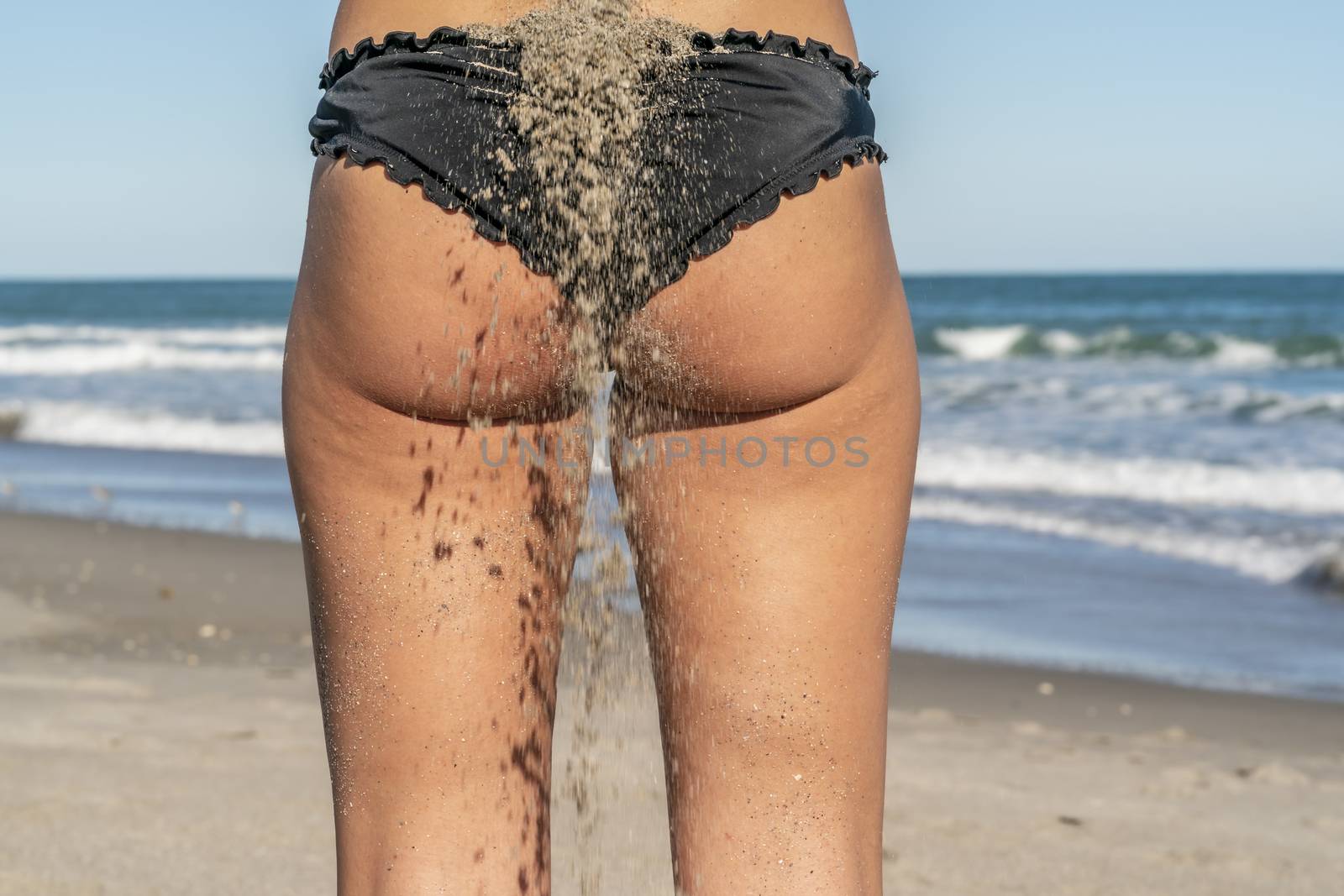 A gorgeous bikini model posing in a beach environment