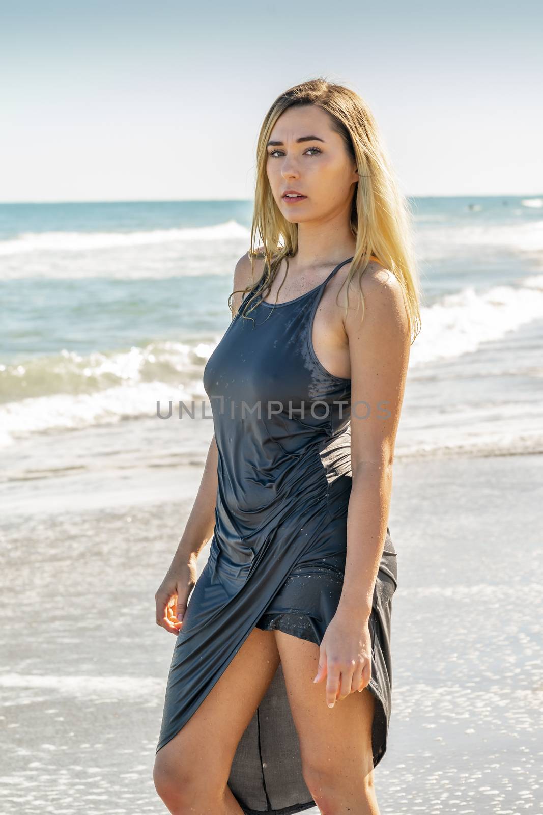 A gorgeous young blonde female enjoys a day at the beach alone