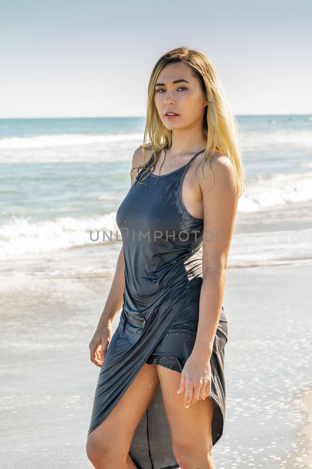 A gorgeous young blonde female enjoys a day at the beach alone