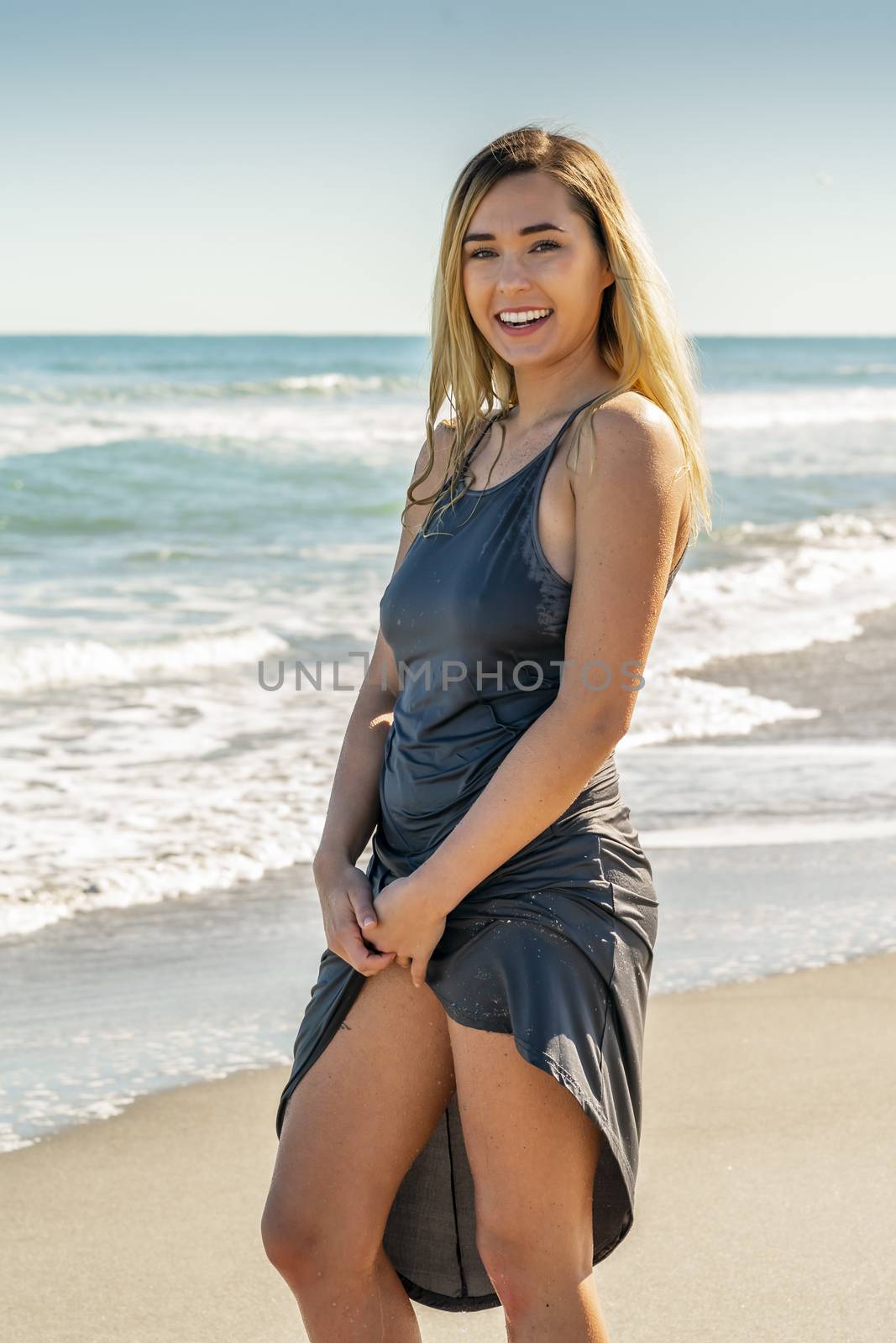 A gorgeous young blonde female enjoys a day at the beach alone