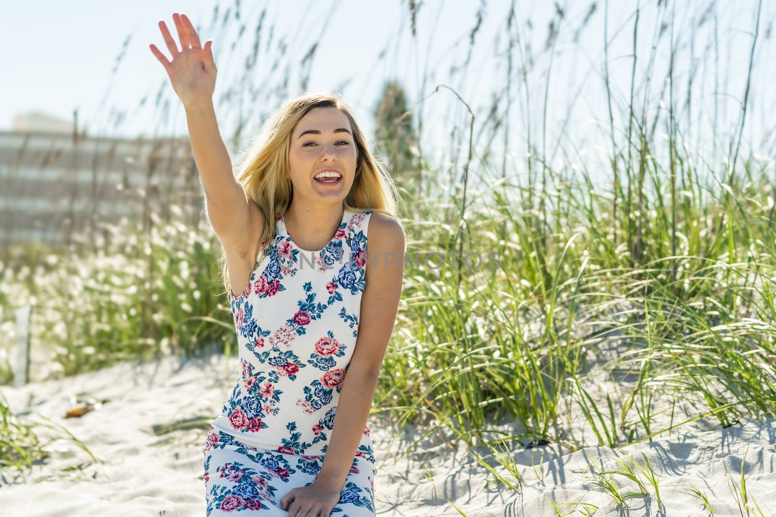 A gorgeous young blonde female enjoys a day at the beach alone
