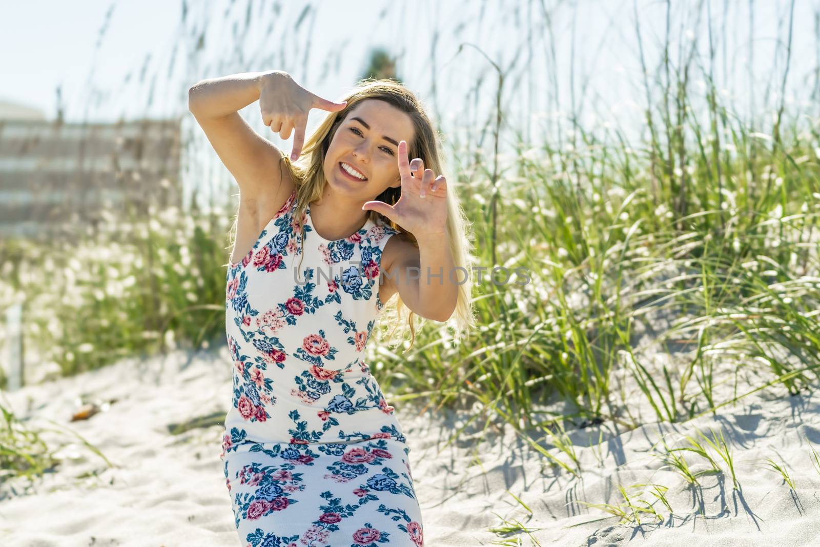 A gorgeous young blonde female enjoys a day at the beach alone