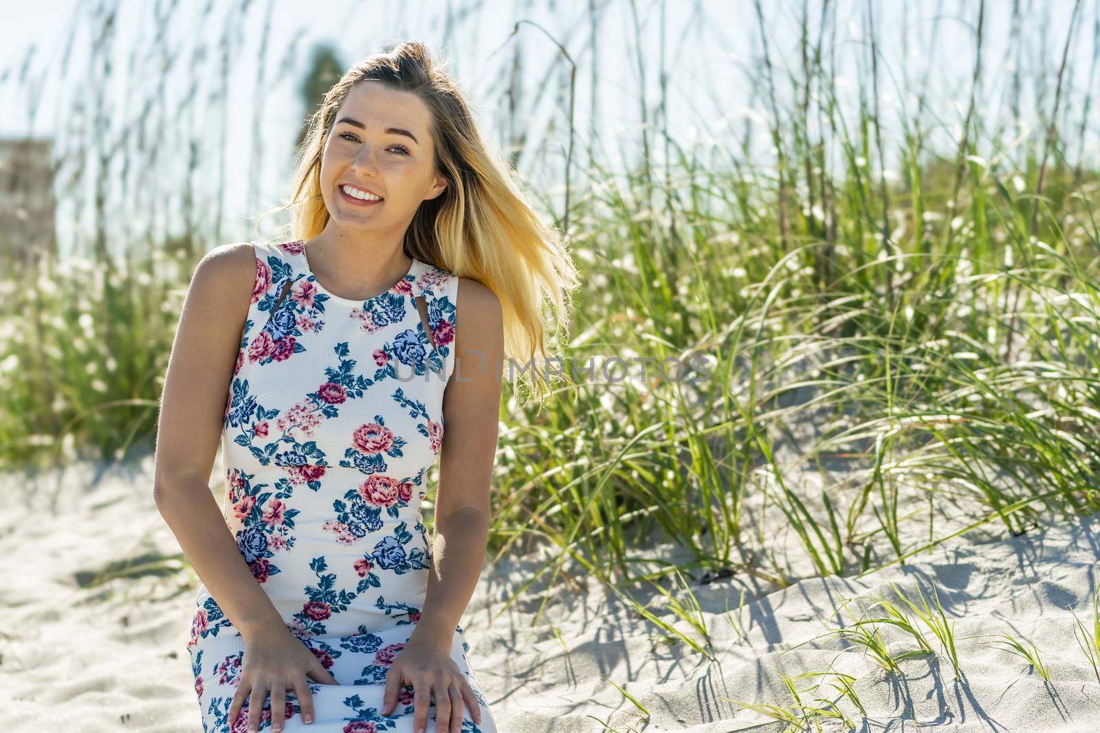 A gorgeous young blonde female enjoys a day at the beach alone