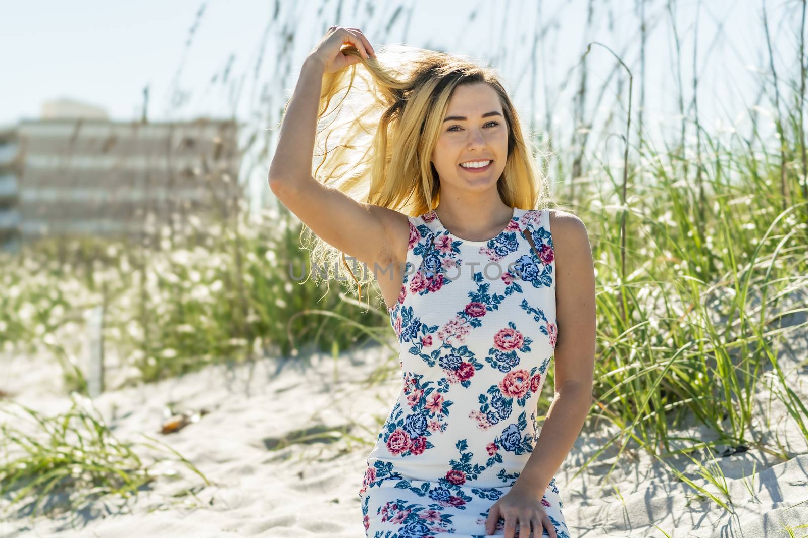A gorgeous young blonde female enjoys a day at the beach alone