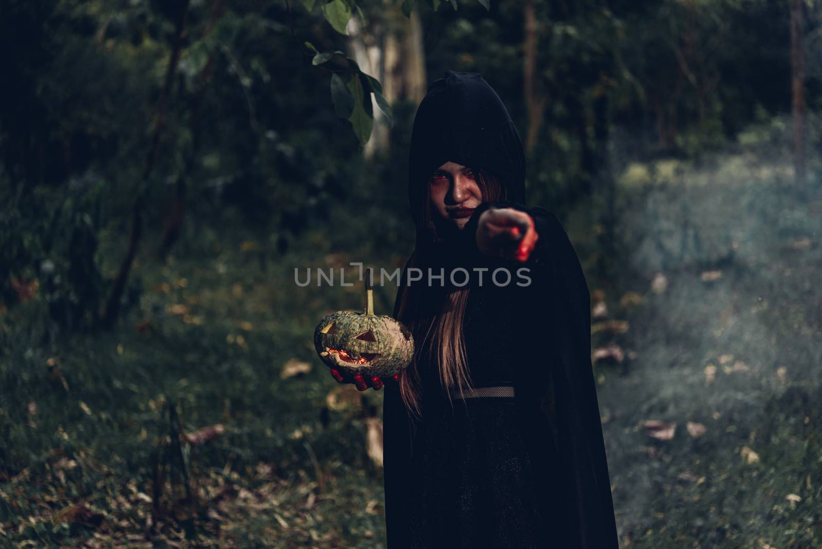Woman ghost horror her holding pumpkin on hand and have magic wand, halloween day concept