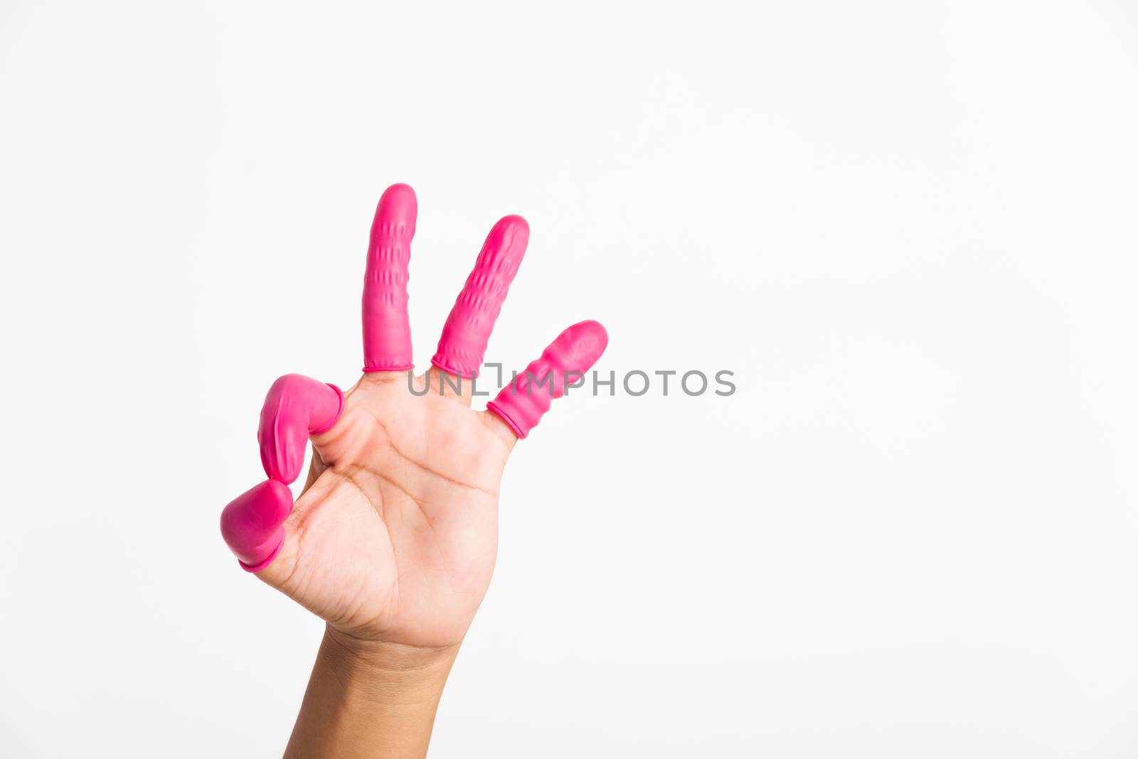 Woman hand wearing pink finger cots rubber protect help prevent fingerprints on the finger touched piece with OK sign gesturing, studio shot isolated on white background