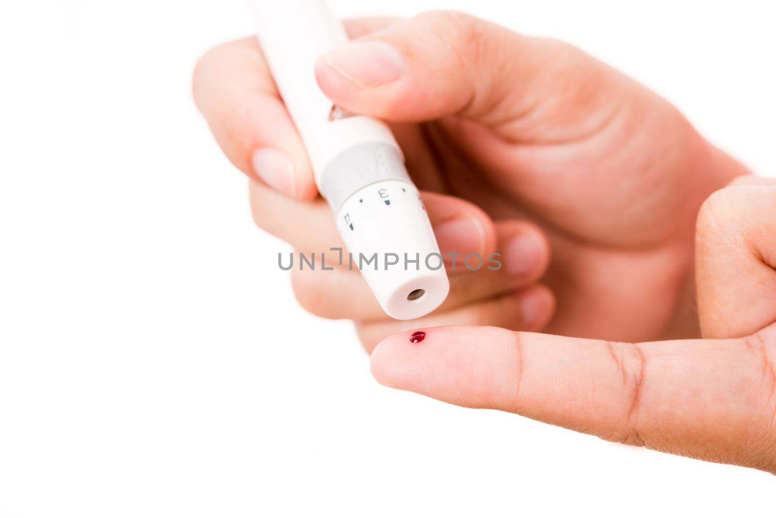 Closeup woman measuring glucose level using a hand test lancelet on the finger she monitors high blood sugar diabetes and glycemic health care concept