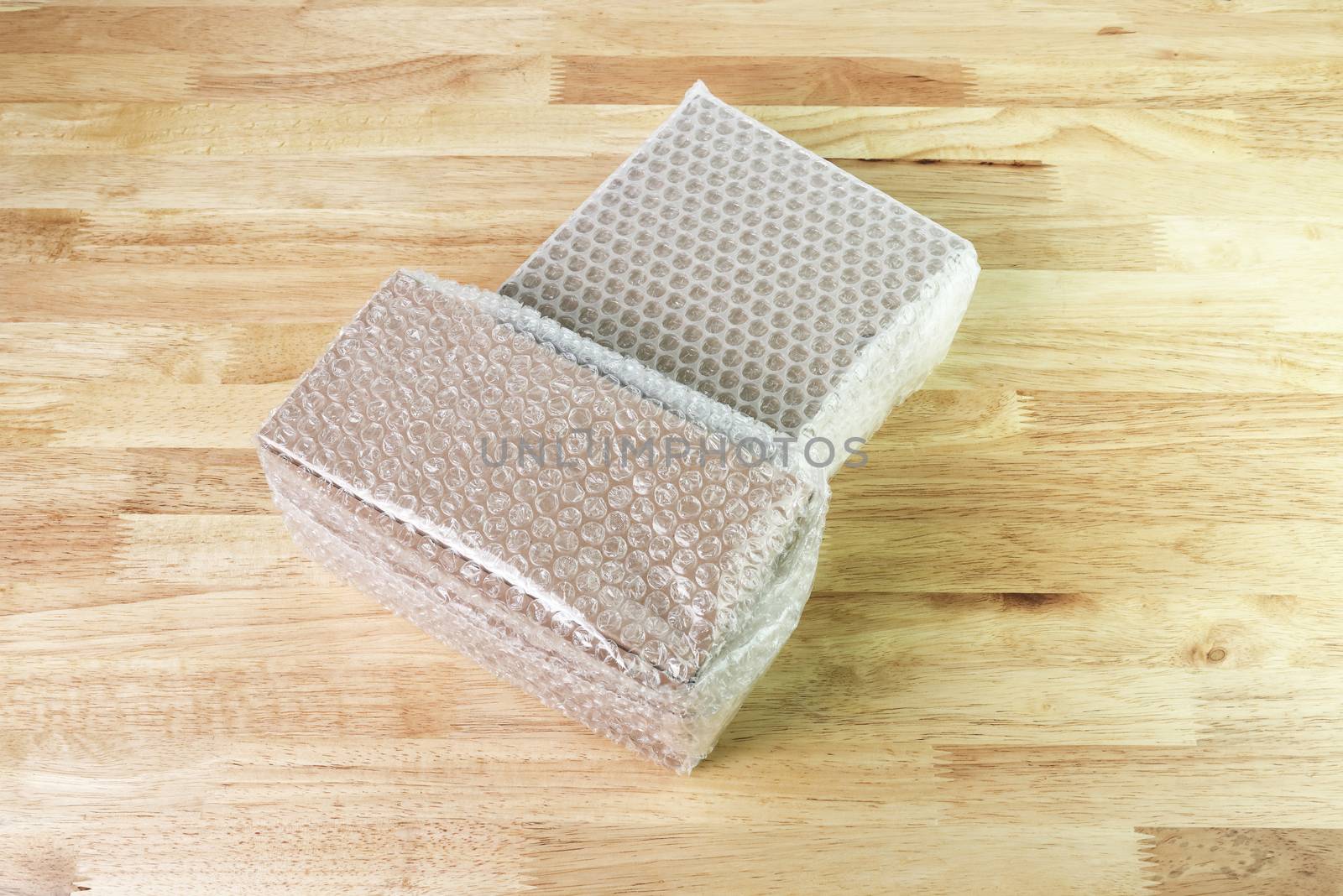 Bubbles covering the box by bubble wrap for protection product cracked on wood table 