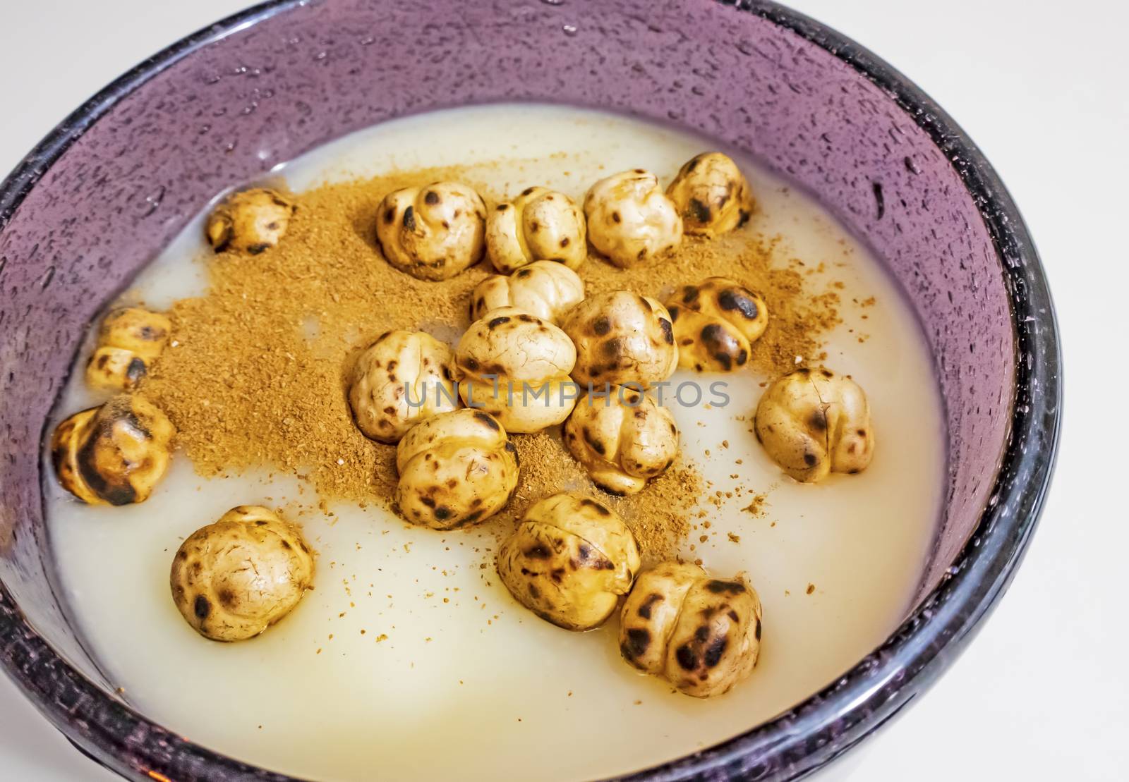 traditional turkish drink boza in glass with cinnamon powder and roasted chickpeas