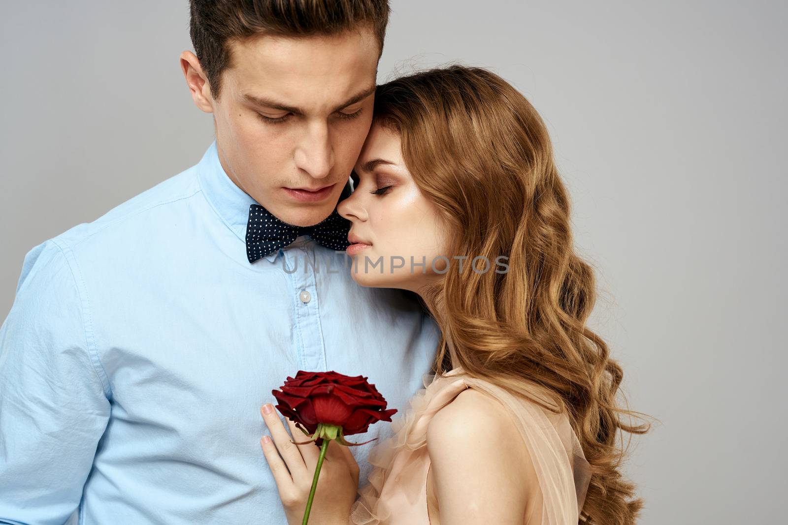 beautiful couple relationship rose gift as romance hug light background by SHOTPRIME