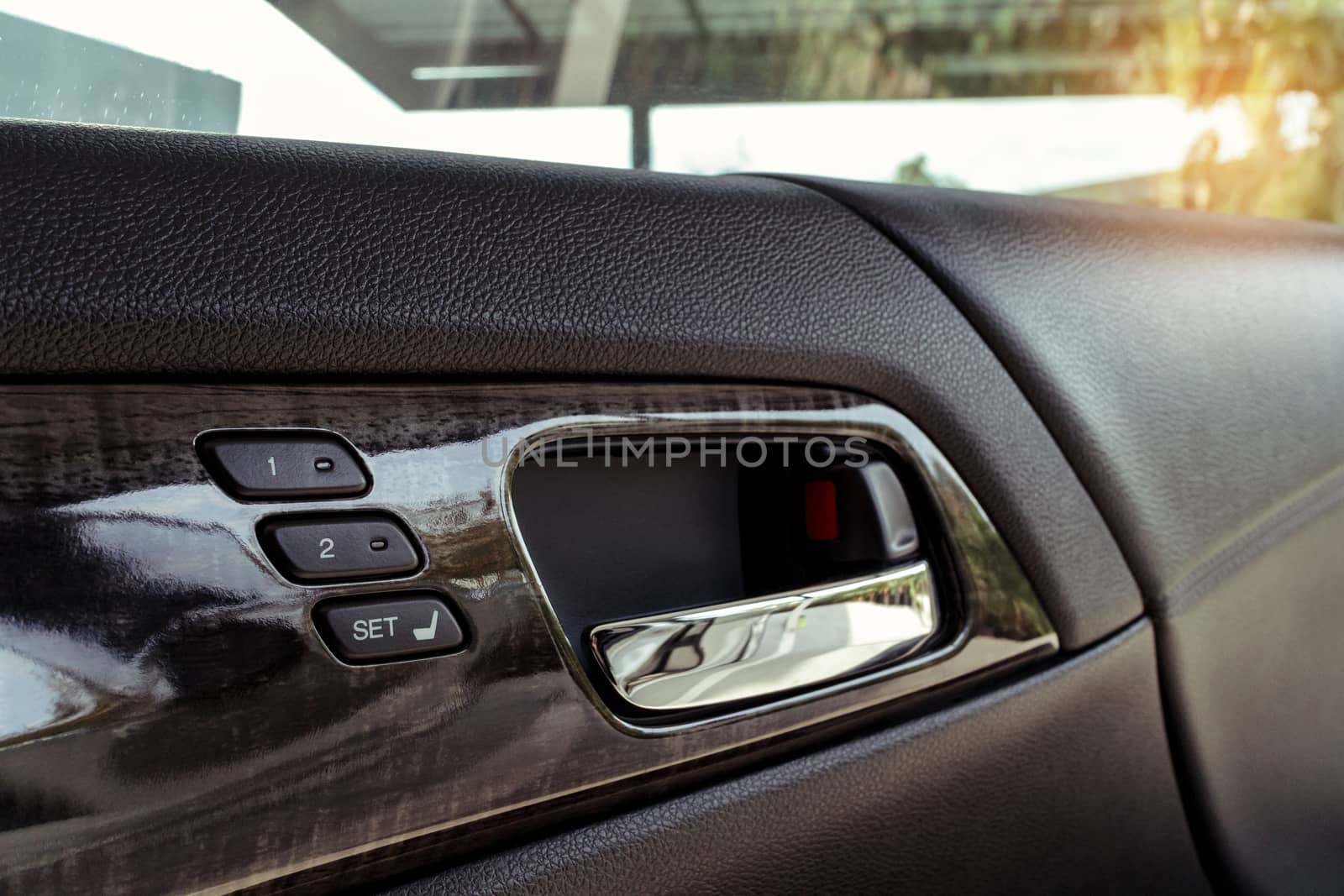 seat control buttons and car door opener in modern car, shallow depth of field