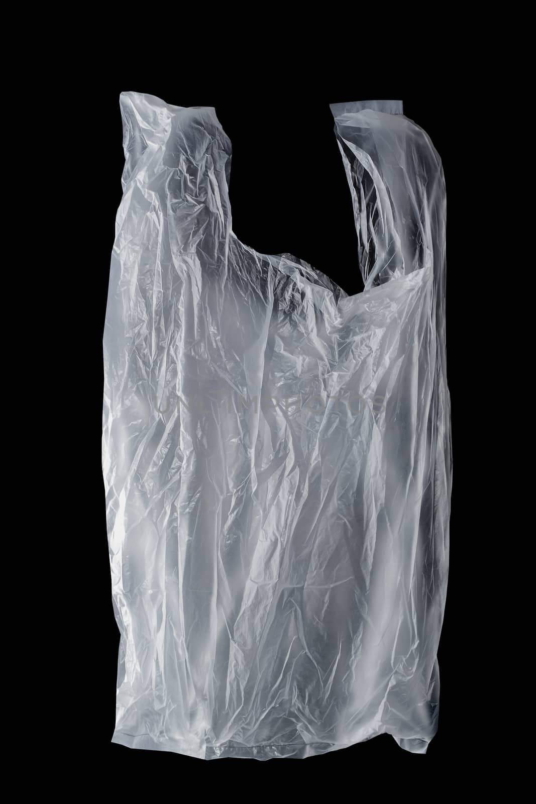 crumpled single-use plastic bag on black background, polyethylene plastic, green environment concept
