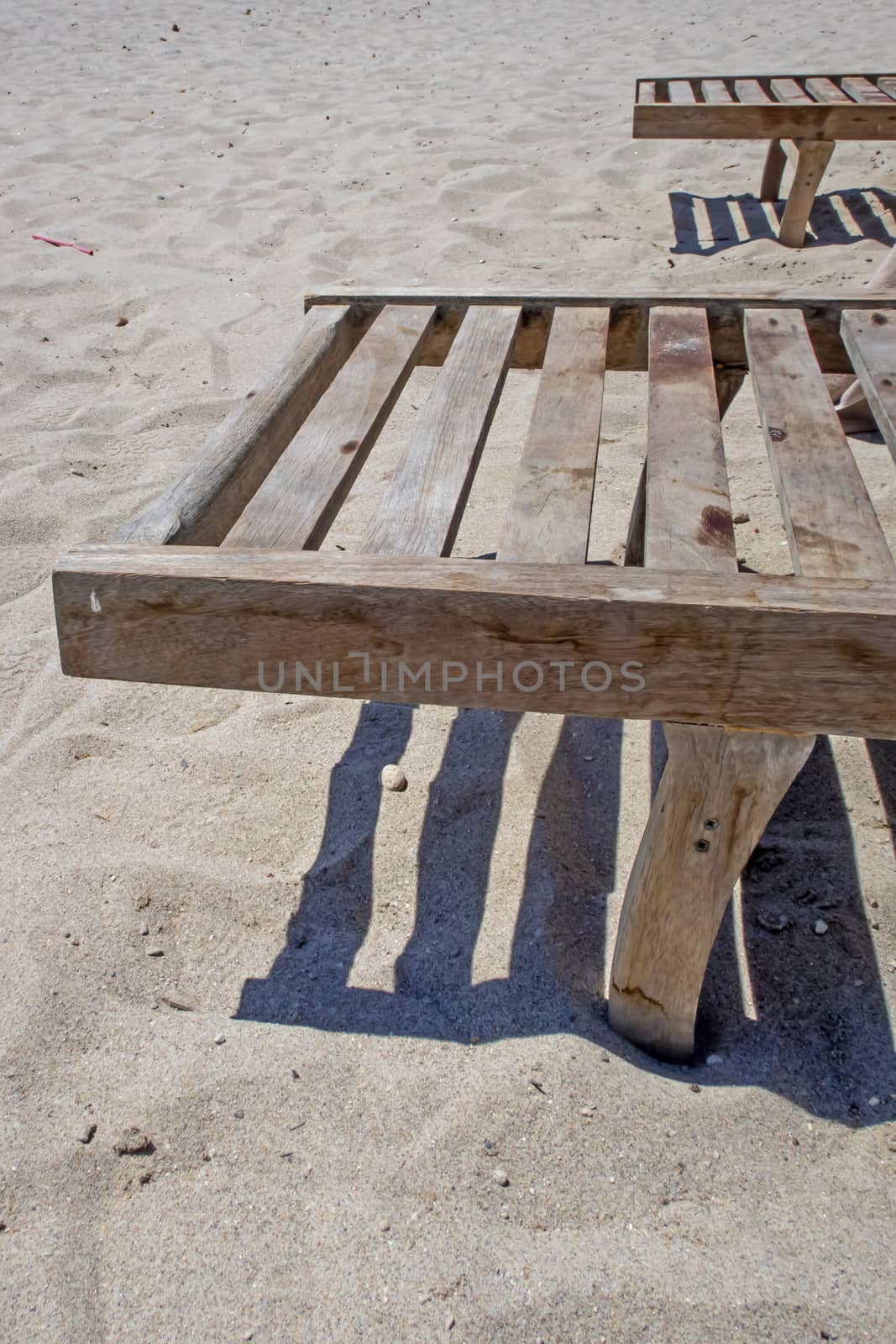 wooden sun lounger chair for sunbathing on the beach