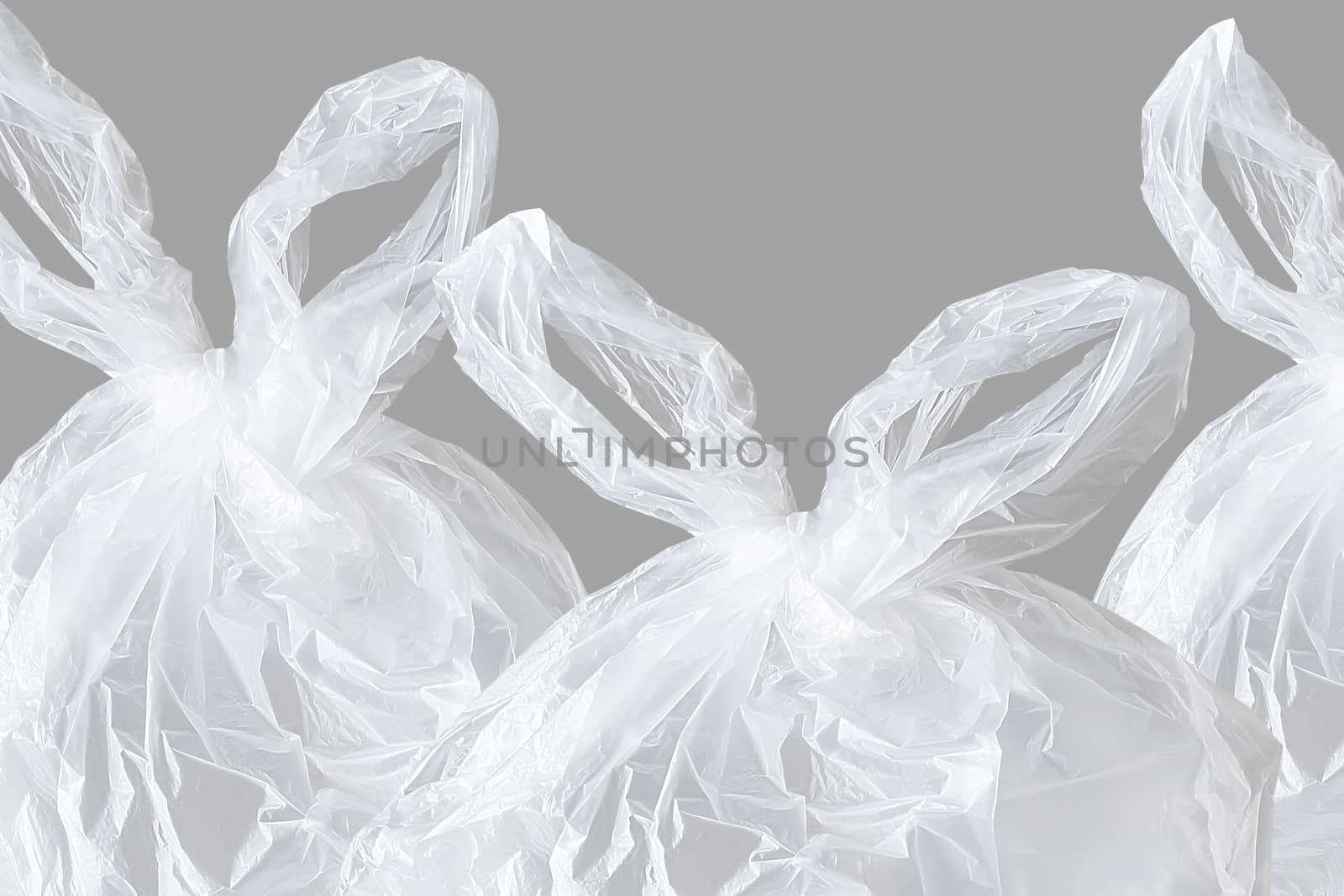 single-use plastic bags on grey background, polyethylene plastic, green environment concept