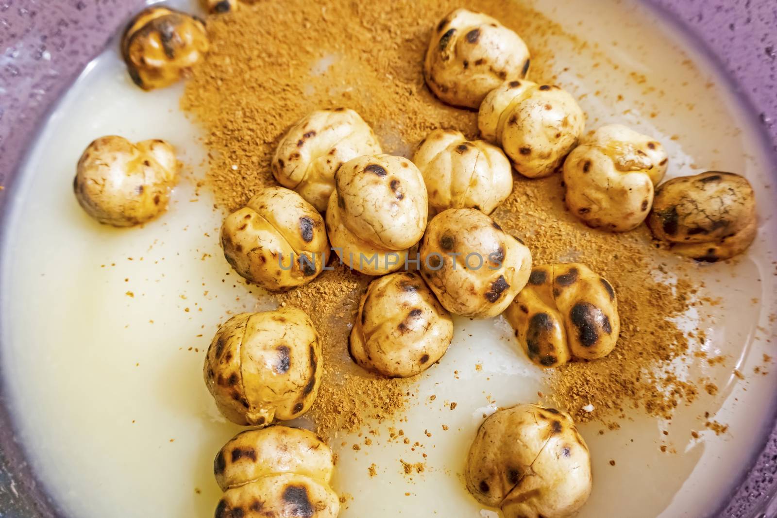 traditional turkish drink boza in glass with cinnamon powder and roasted chickpeas