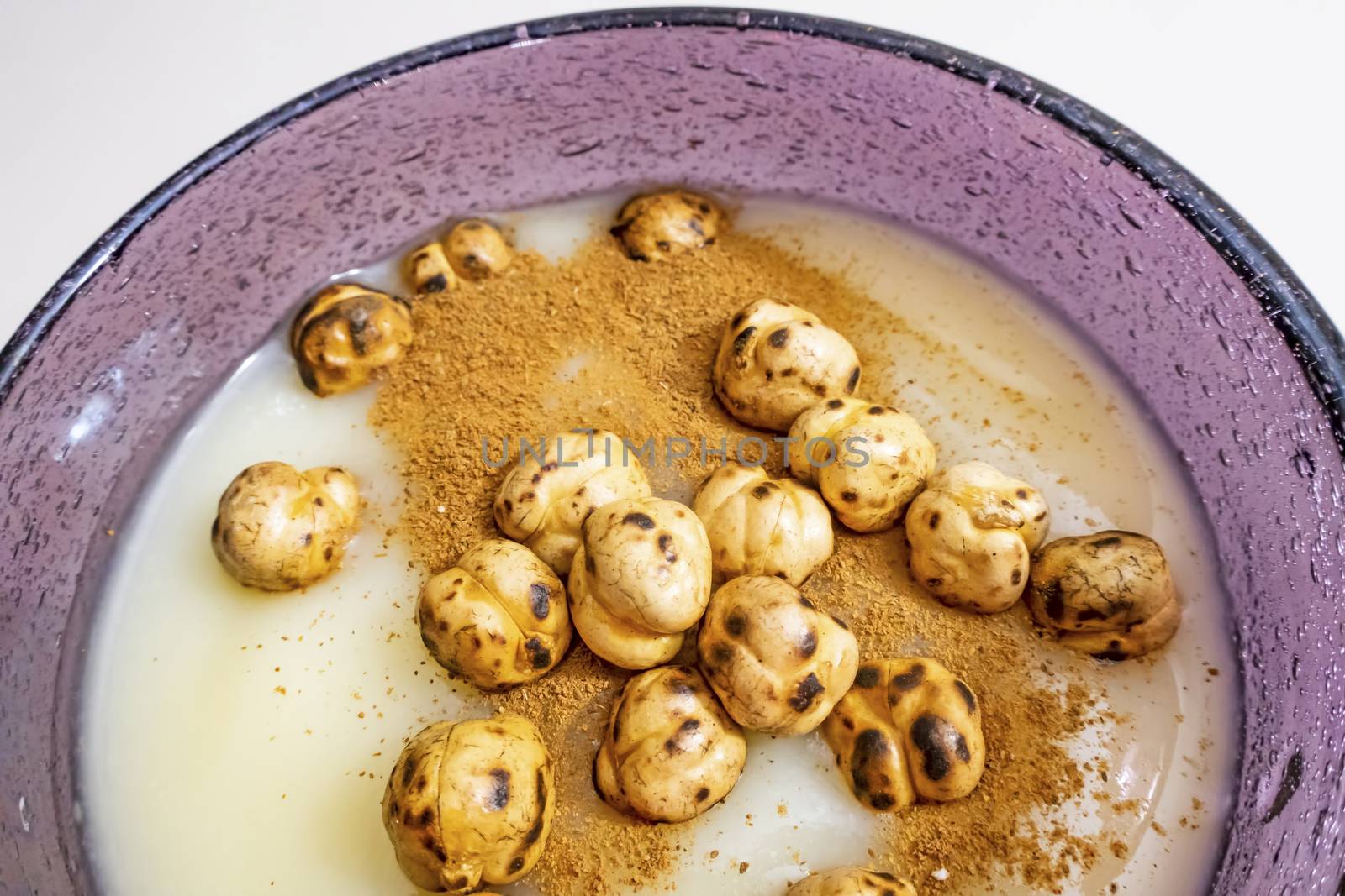 traditional turkish drink boza in glass with cinnamon powder and roasted chickpeas