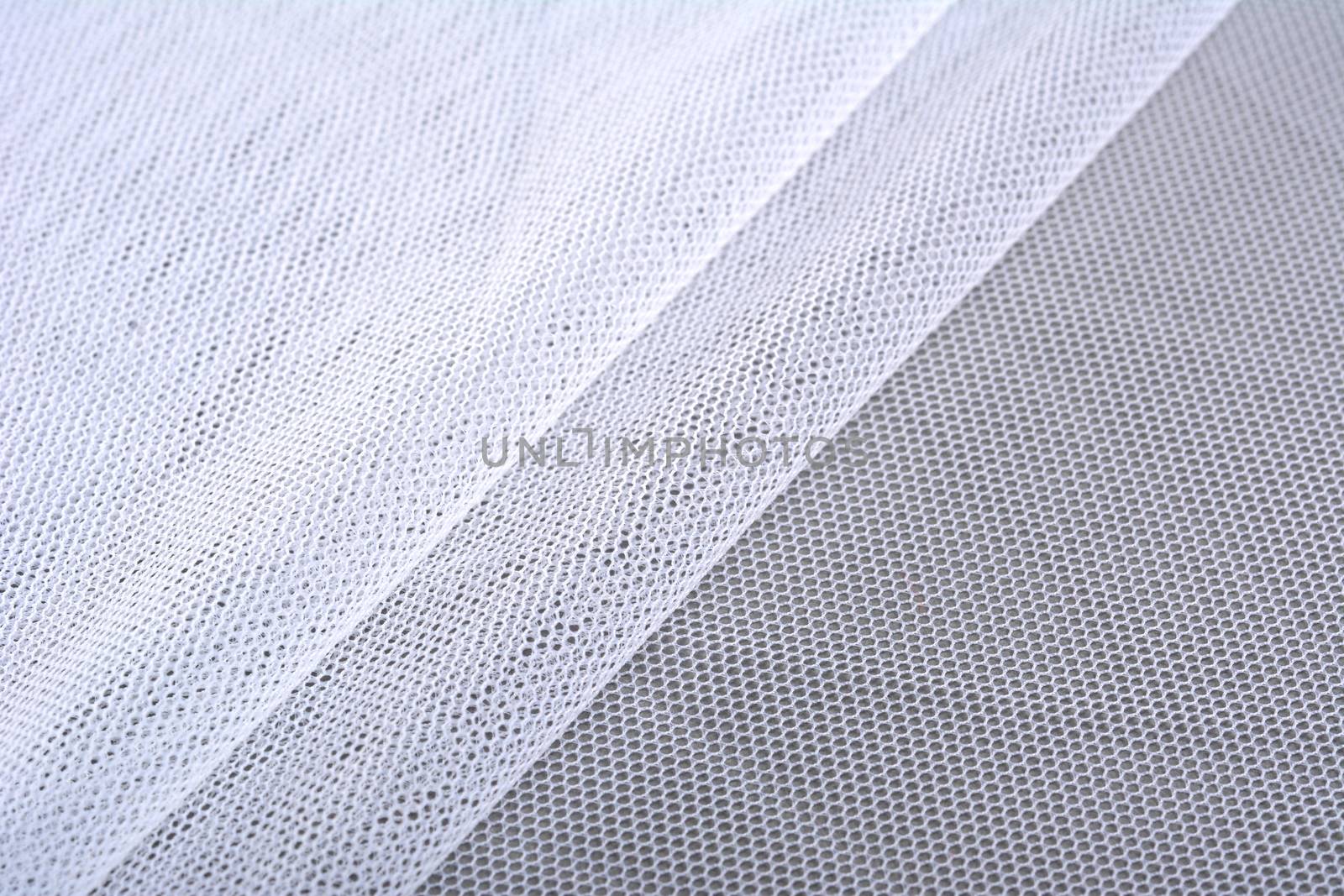 white Knitted elastic fabric, weaving of threads texture, crumpled fold. For underwear, sports clothes and swimwear. Space for text.