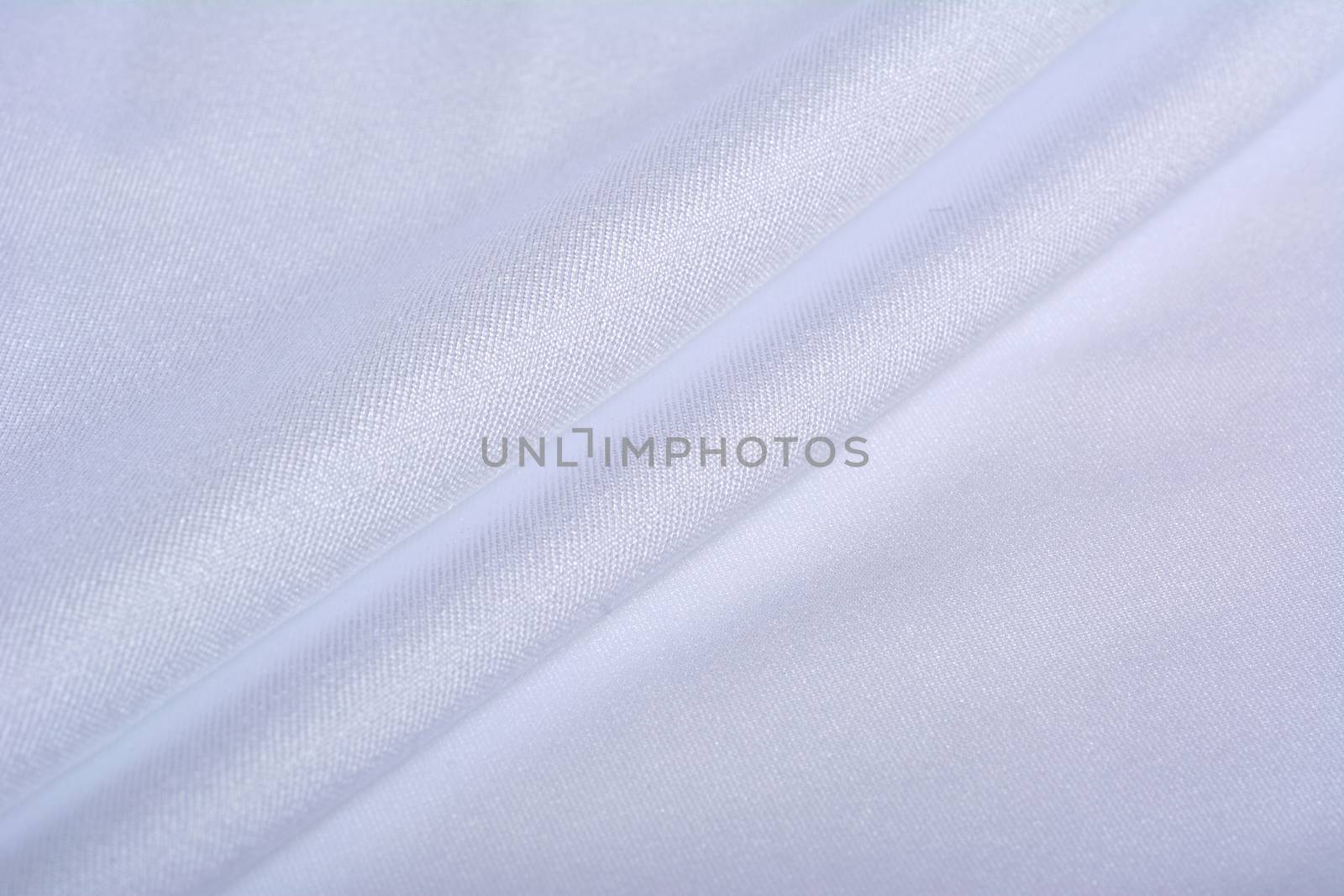 white Knitted elastic fabric, weaving of threads texture, crumpled fold. For underwear, sports clothes and swimwear. Space for text.