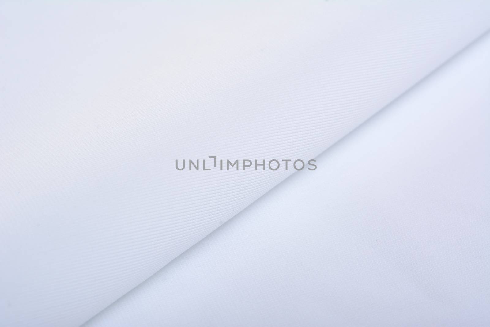 white Knitted elastic fabric, weaving of threads texture, crumpled fold. For underwear, sports clothes and swimwear. Space for text.