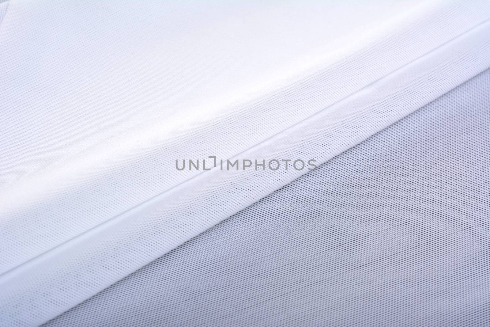 white Knitted elastic fabric, weaving of threads texture, crumpled fold. For underwear, sports clothes and swimwear. Space for text.