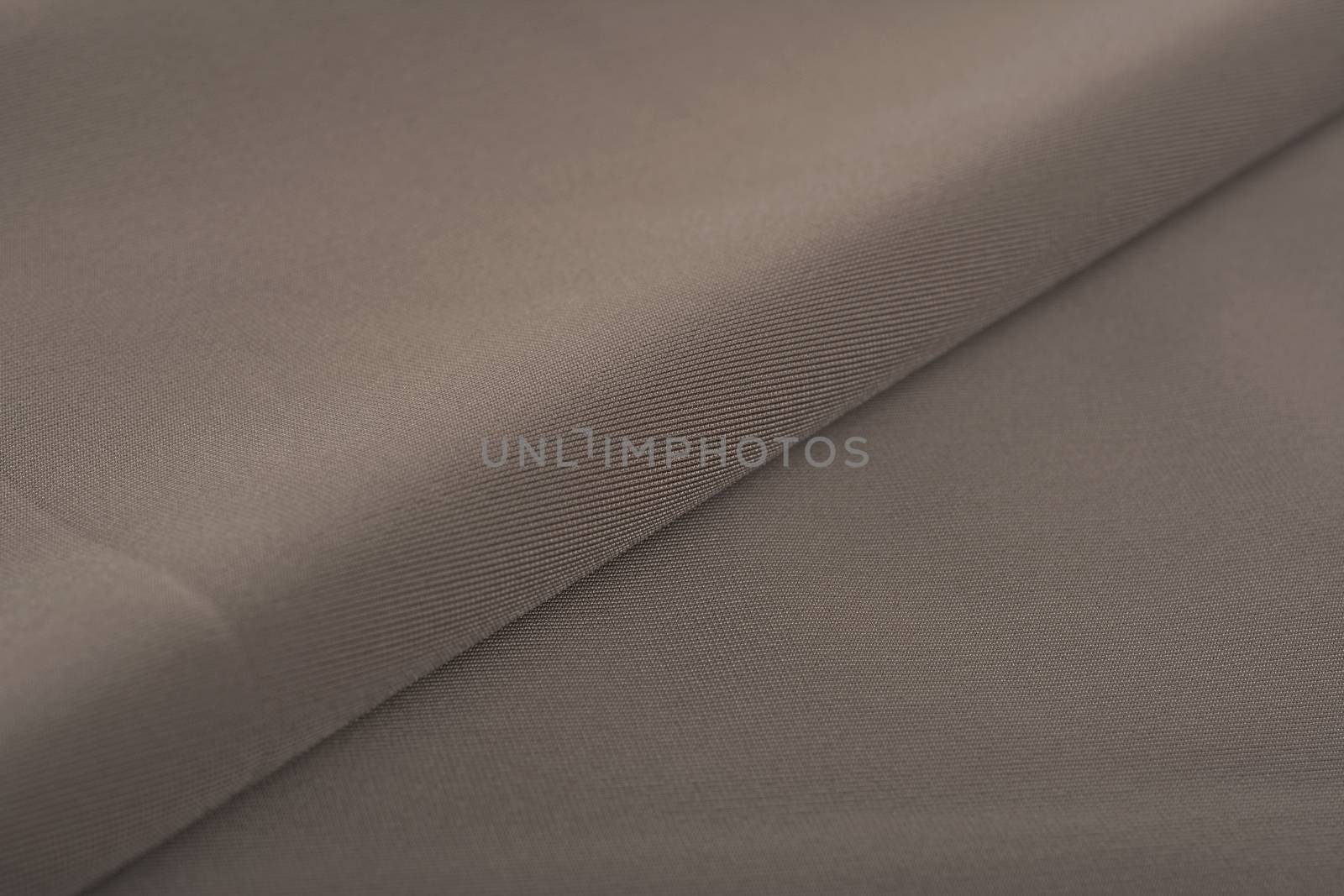 khaki Knitted elastic fabric, weaving of threads texture, crumpled fold. For underwear, sports clothes and swimwear. Space for text.