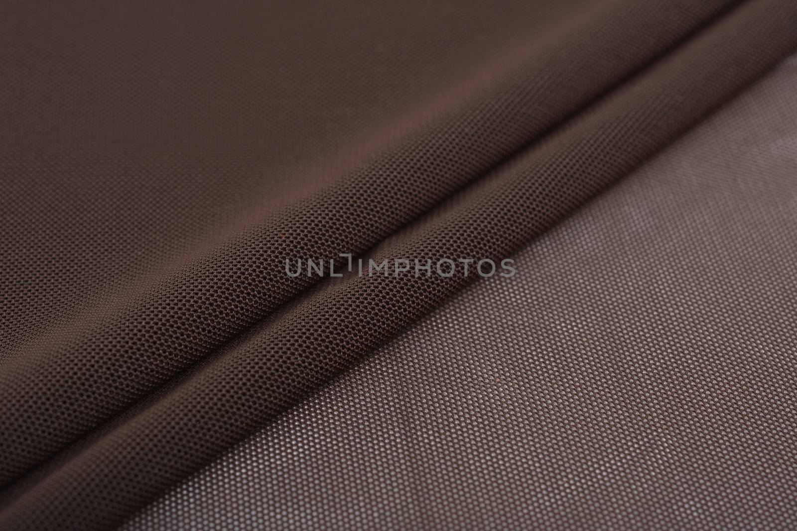 brown Knitted elastic fabric, weaving of threads texture, crumpled fold. For underwear, sports clothes and swimwear. Space for text.