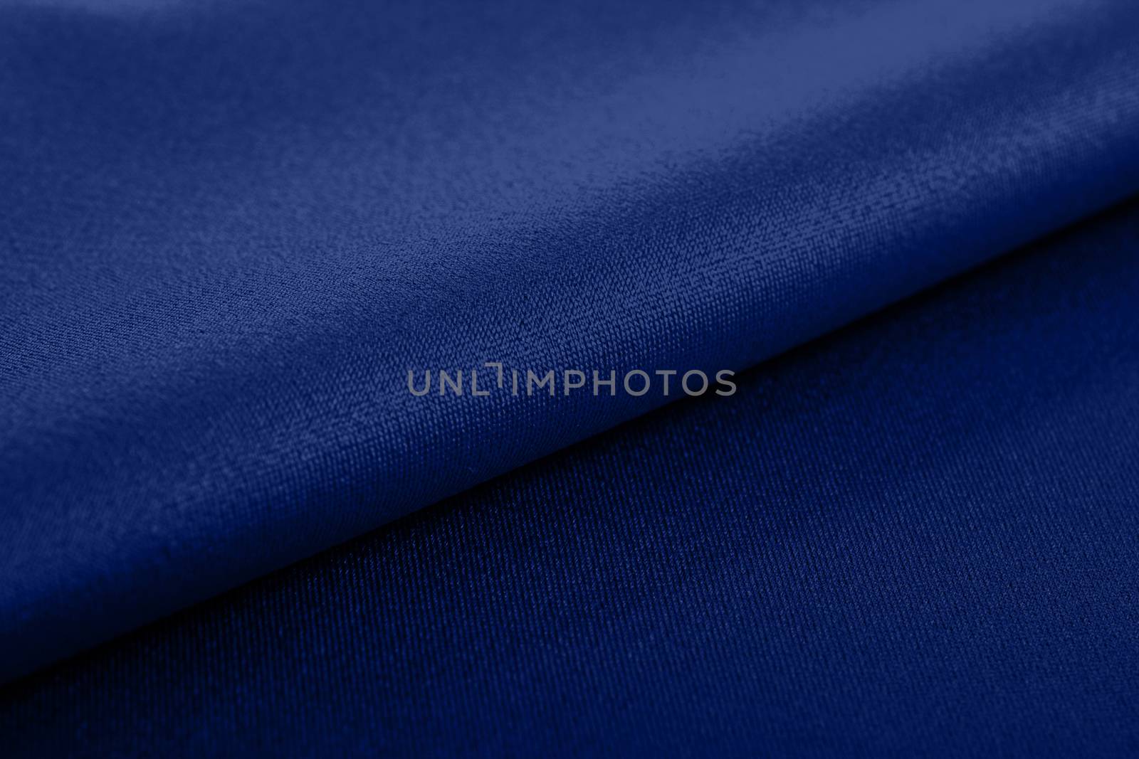 blue Knitted elastic fabric, weaving of threads texture, crumpled fold. For underwear, sports clothes and swimwear. Space for text.