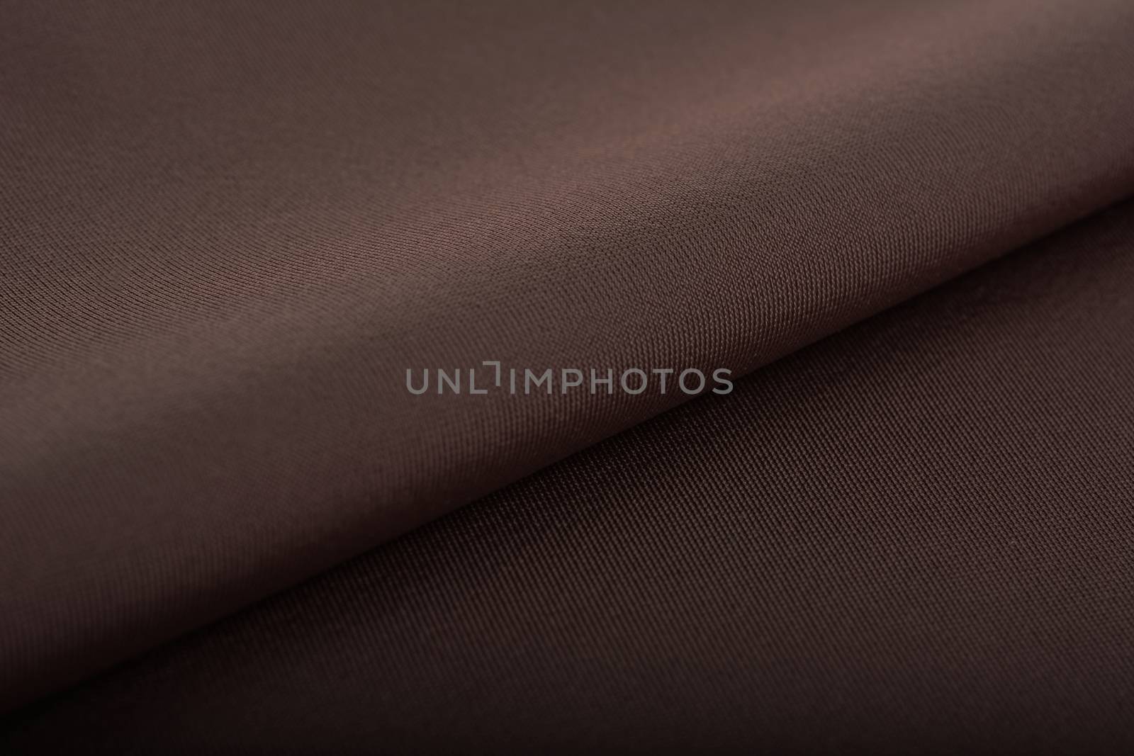 brown Knitted elastic fabric, weaving of threads texture, crumpled fold. For underwear, sports clothes and swimwear. Space for text.