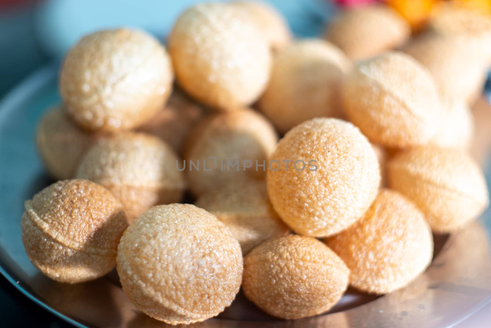 shot of north indian street food snack gol gappe pani puri or puchke being fried from dough in hot oil to make them round hollow golden ball spheres by Shalinimathur