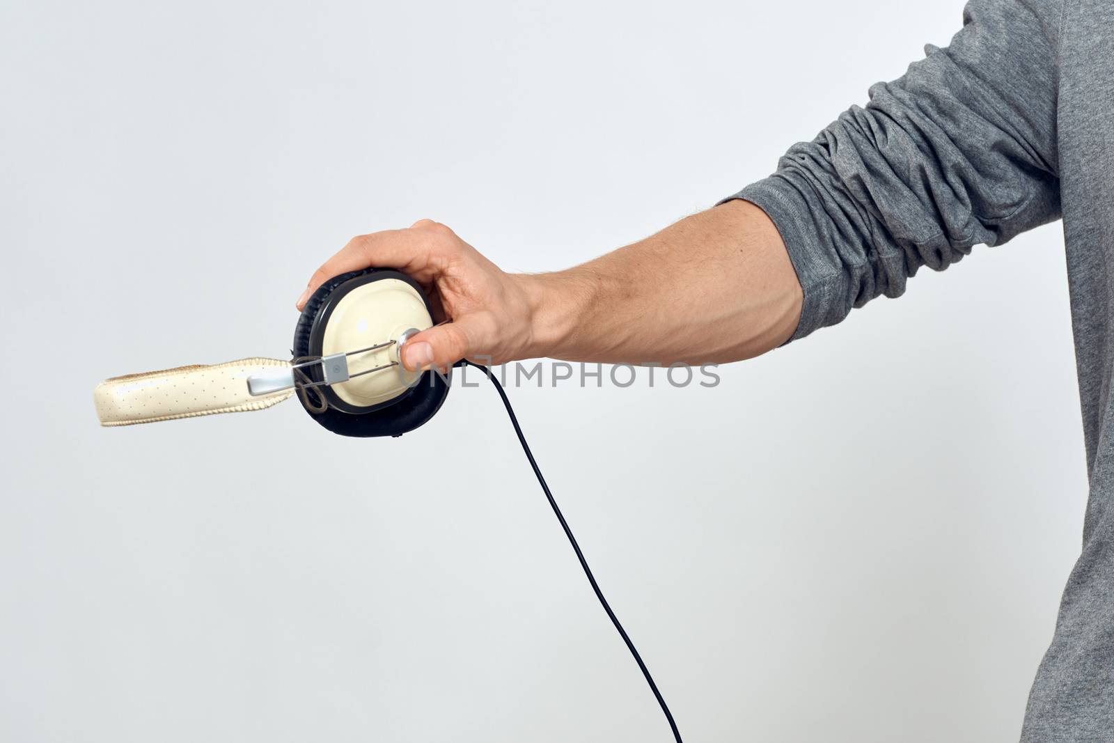 Man holding headphones in the hands of a man lifestyle modern style technology cropped view. High quality photo