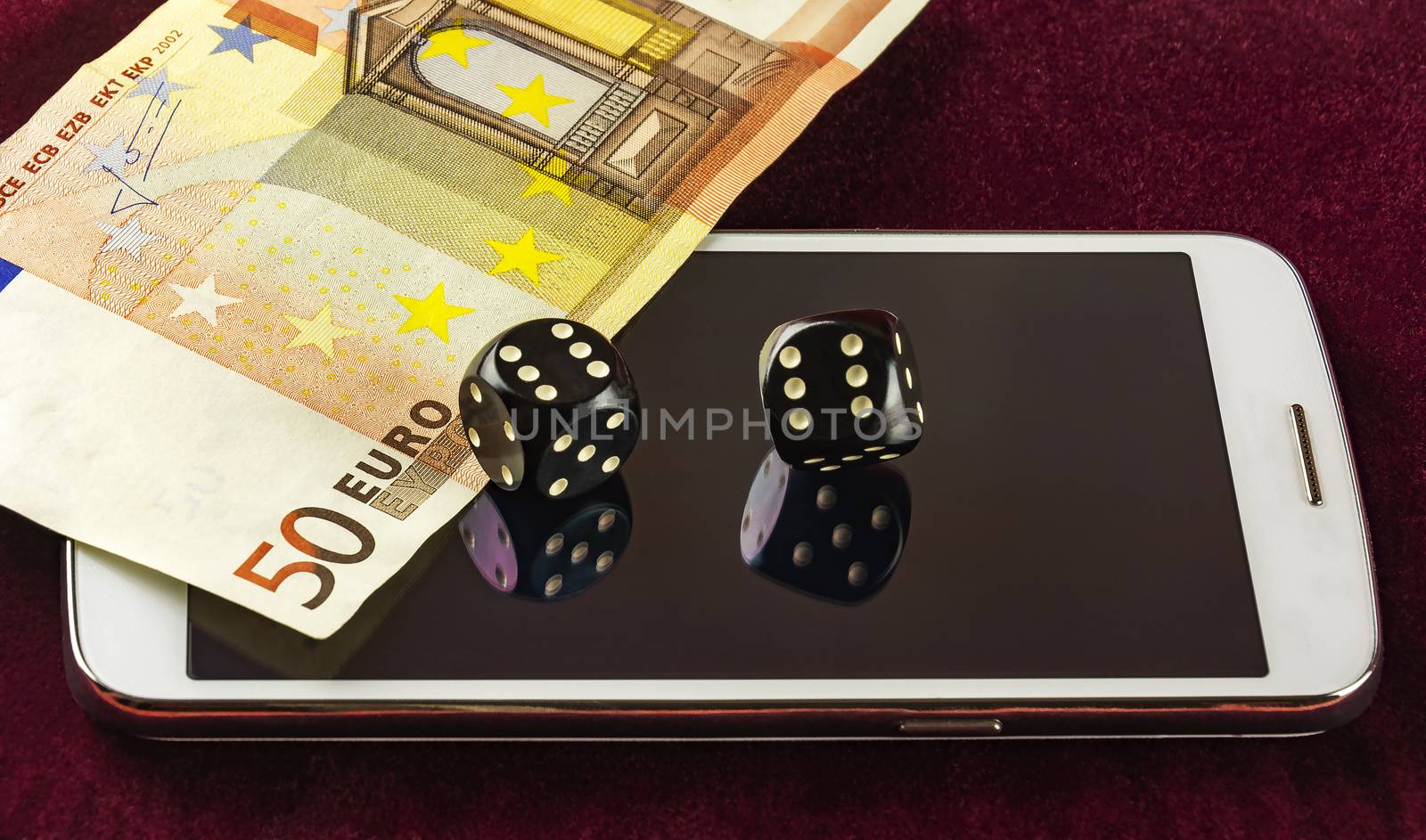 Smartphone, dice poker, and part of fifty euro banknotes by Grommik