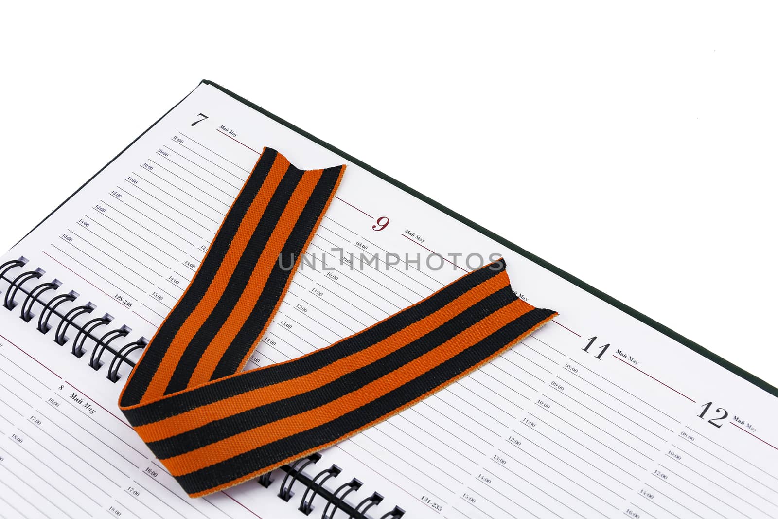 
In an open diary sheet is St. George's ribbon in the form of the letter V