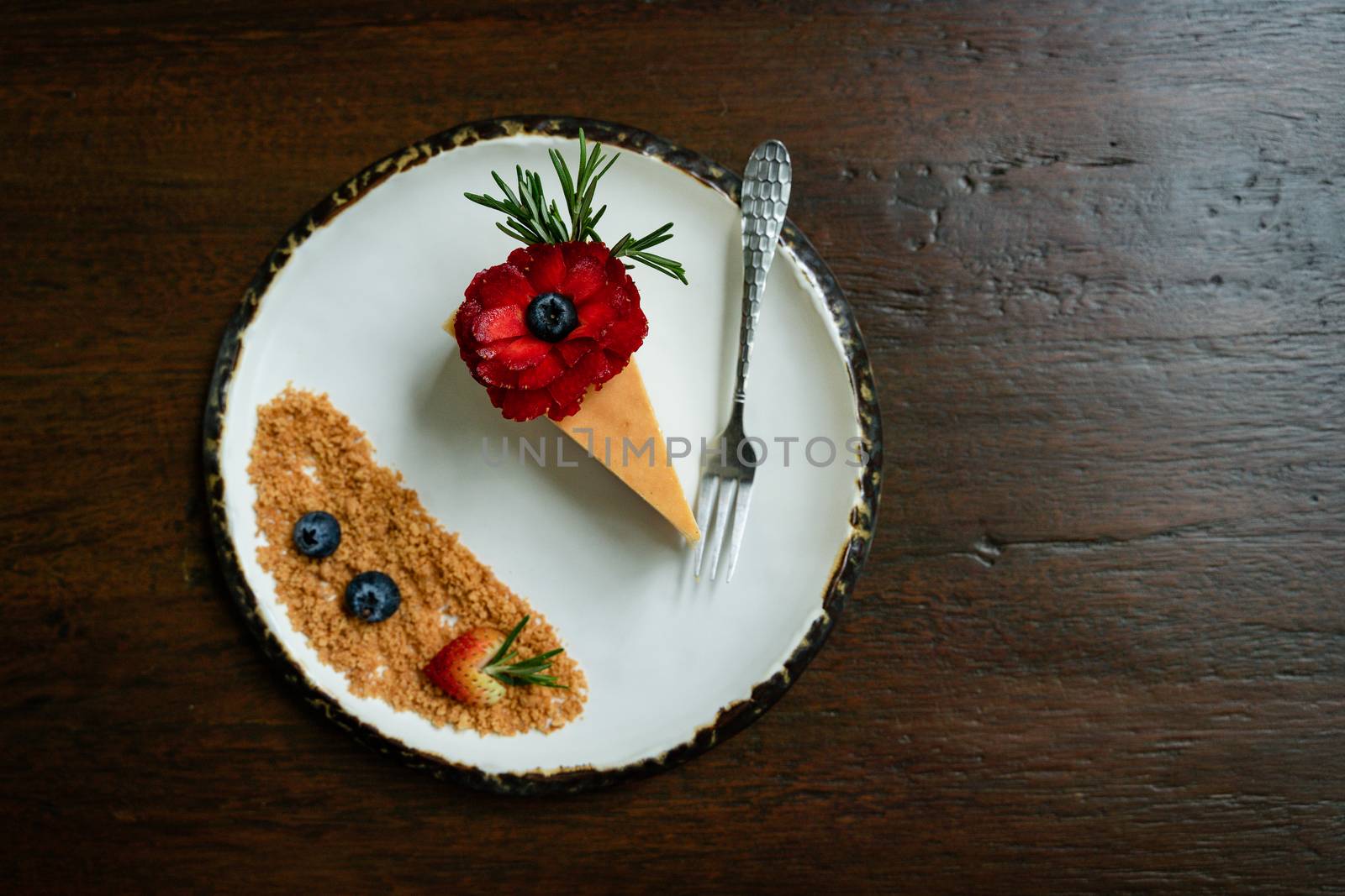 Top view photos of beautifully decorated cakes on white tiled plates and background of old wooden tables