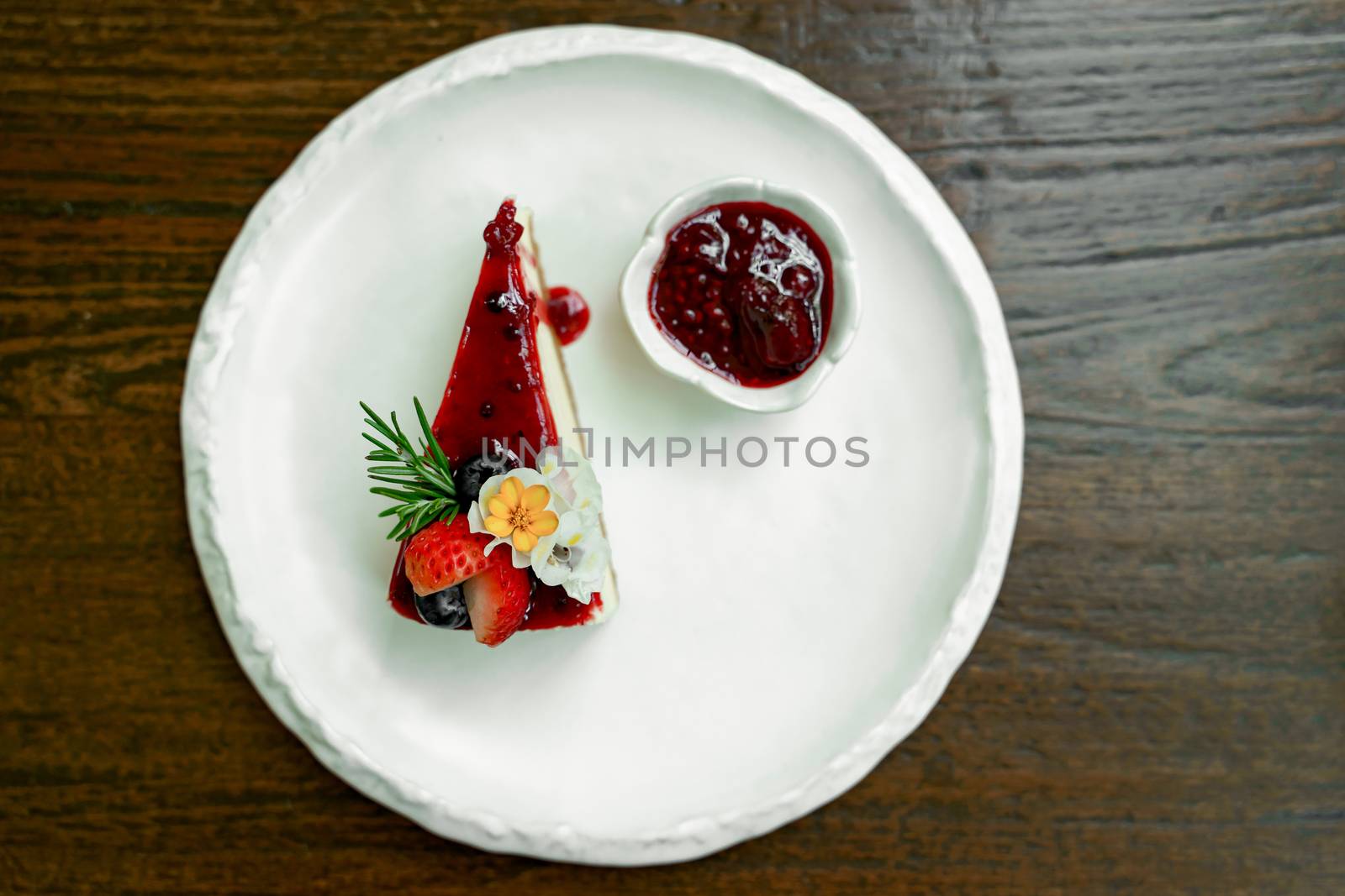 Top view photos of beautifully decorated cakes on white tiled plates and background of old wooden tables