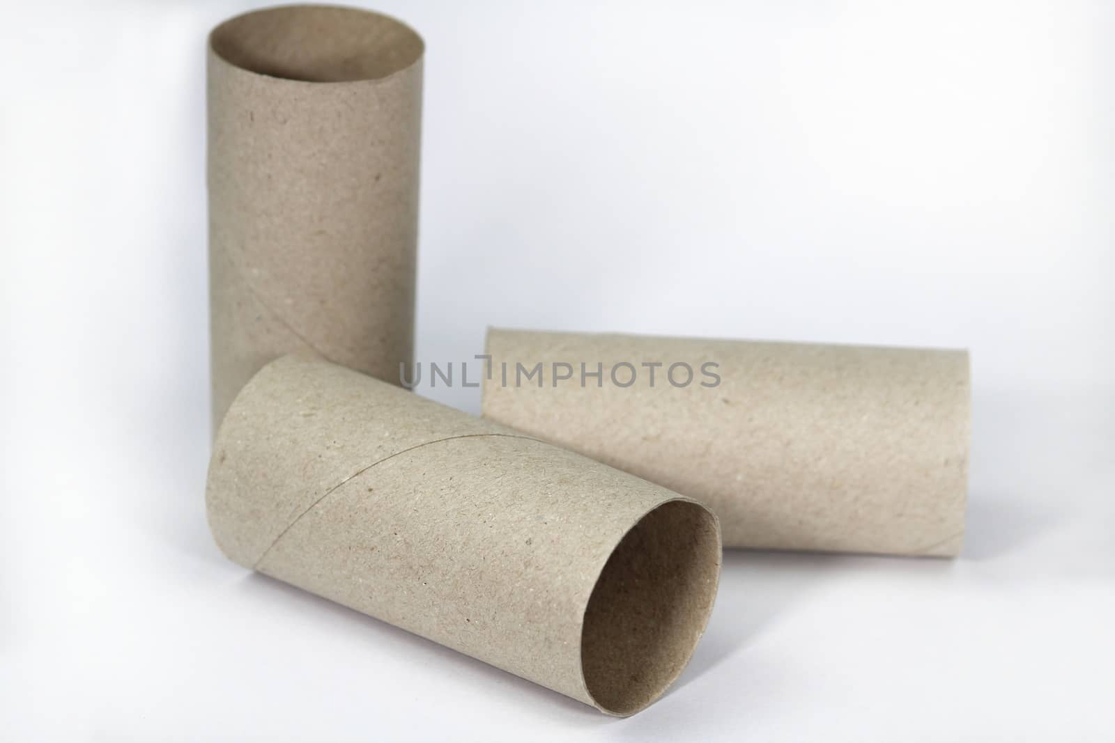 Three Empty toilet paper roll on white background