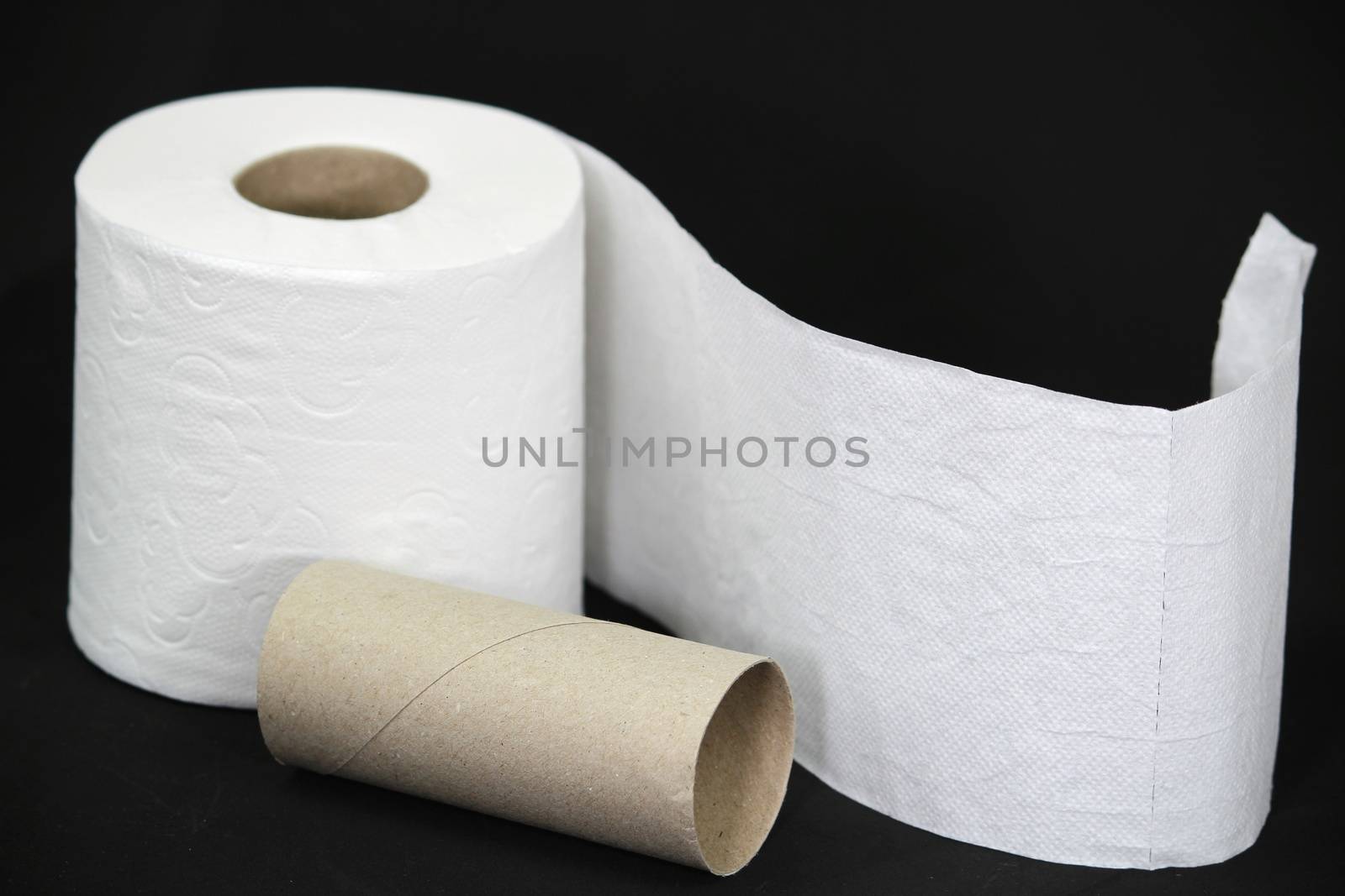 Toilet paper roll on black background by soniabonet