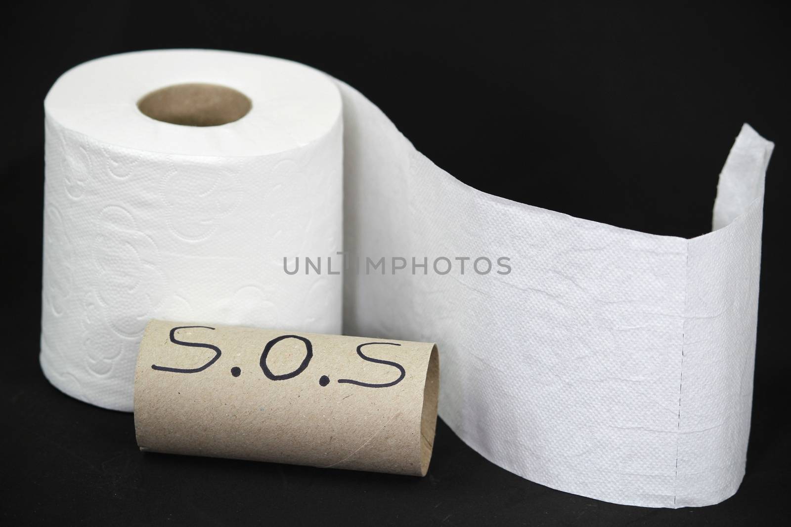 Toilet paper roll on black background by soniabonet