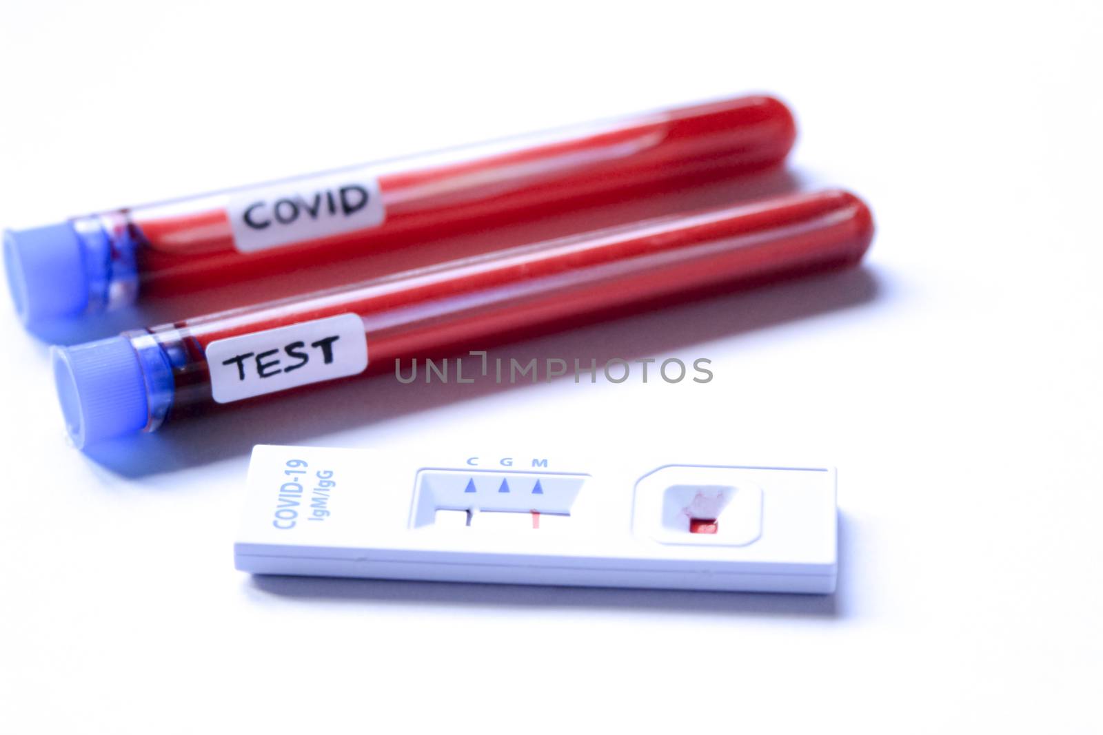 Medical worker placing blood sample on Rapid Diagnostic Test by soniabonet