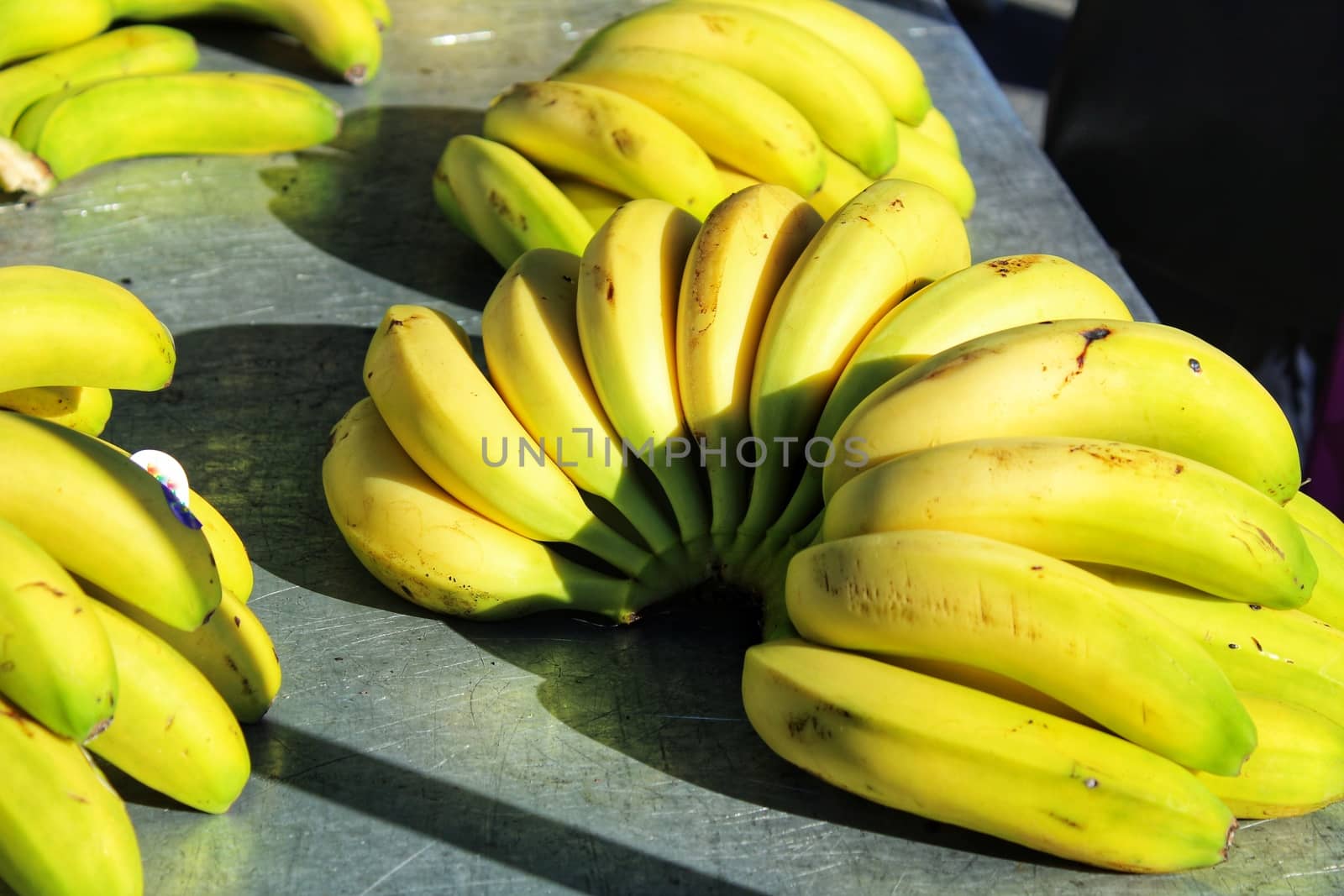 Colorful bananas at a market stall by soniabonet