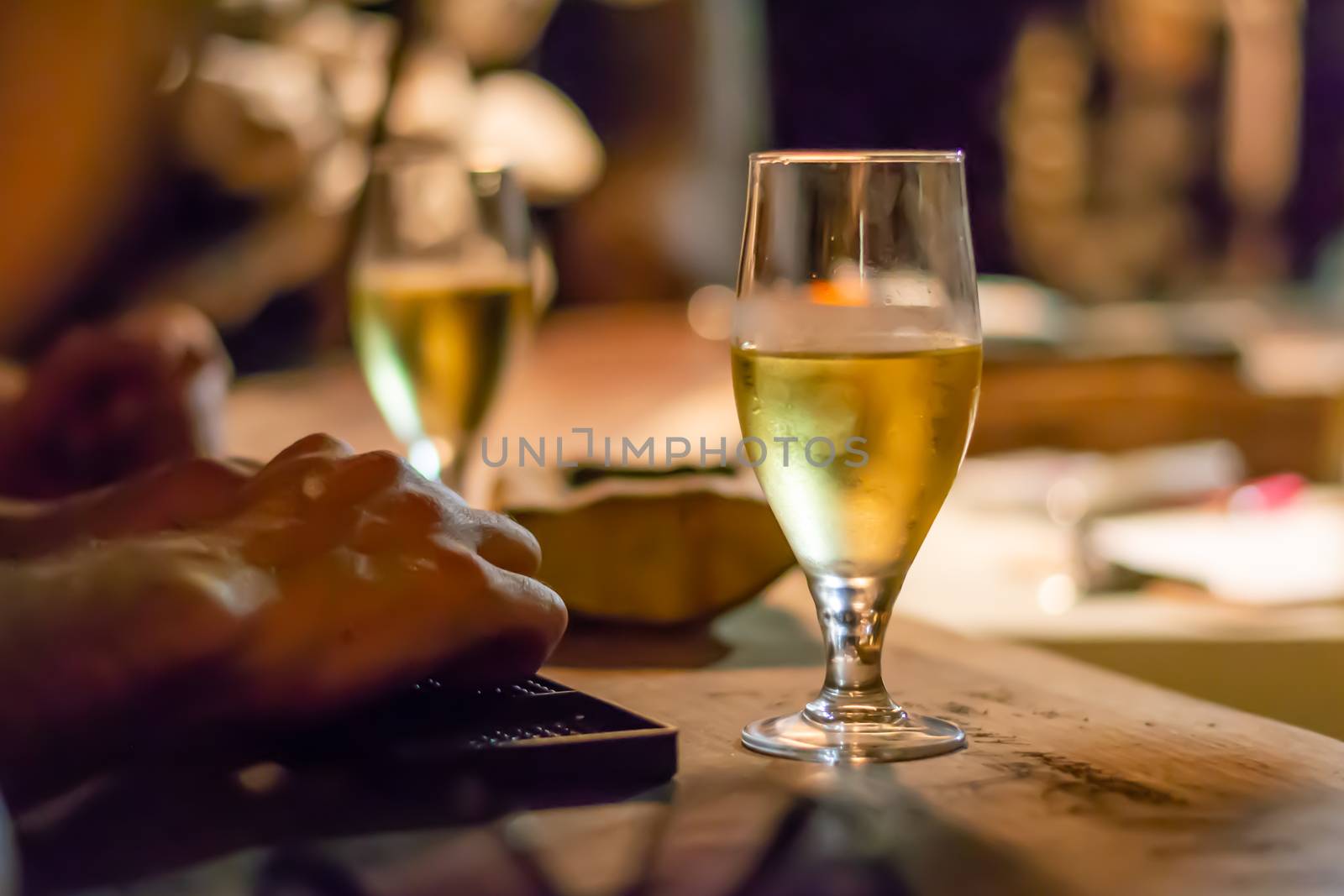 Glass of white wine on rustic bar counter