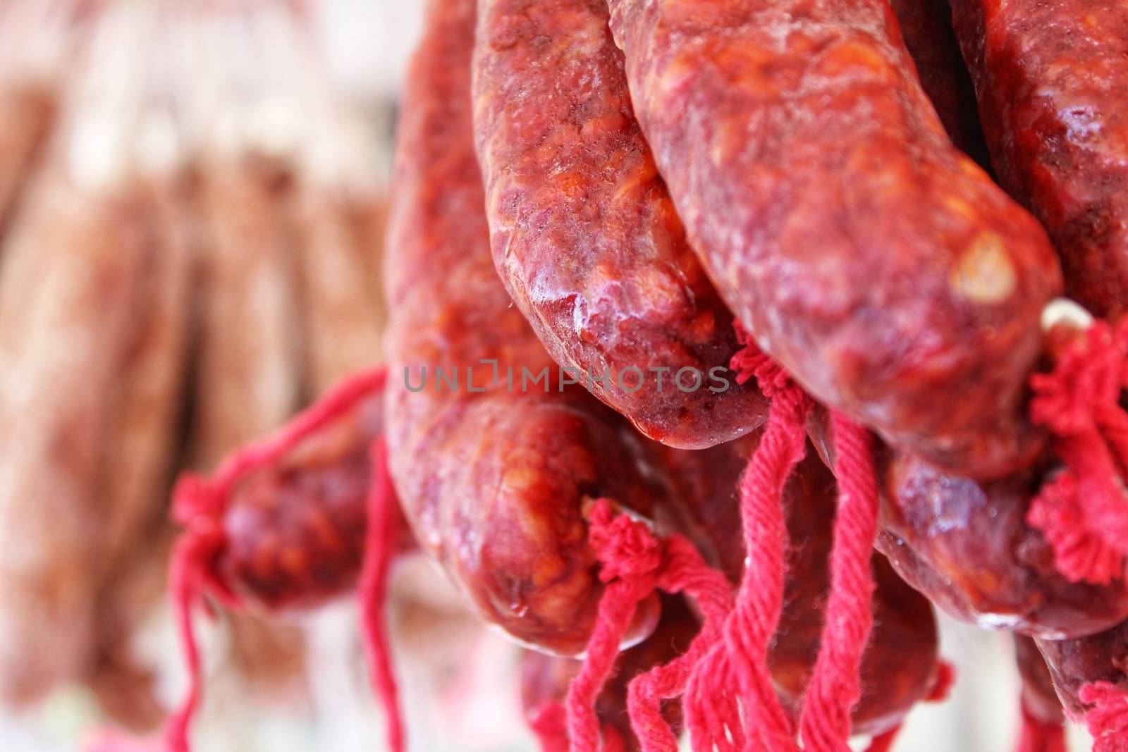 Spicy pork sausage for sale at a market stall by soniabonet