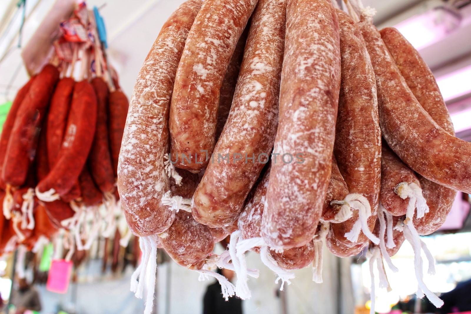 Spicy pork sausage for sale at a market stall by soniabonet