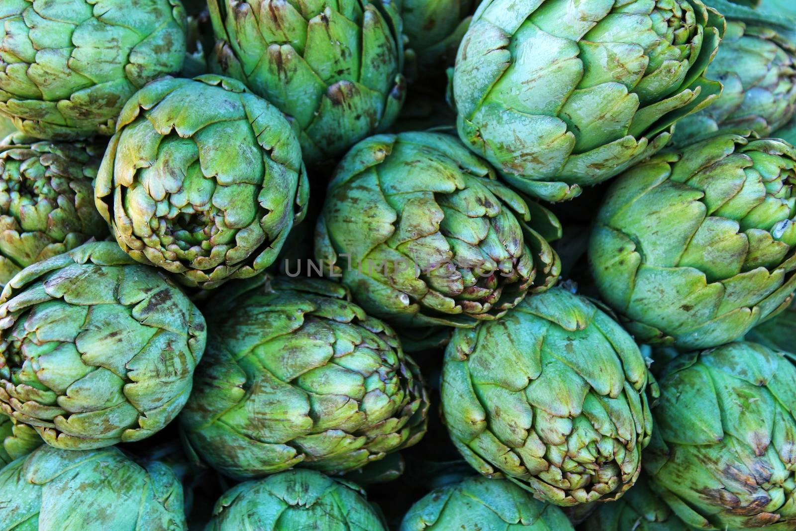 Artichokes for sale at a farmer market stall in Spain