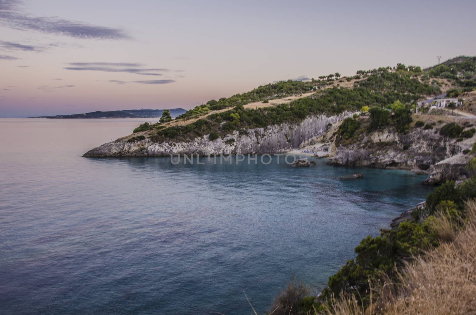 Sunset in a small bay with its cove on the shores of the island of zakynthos