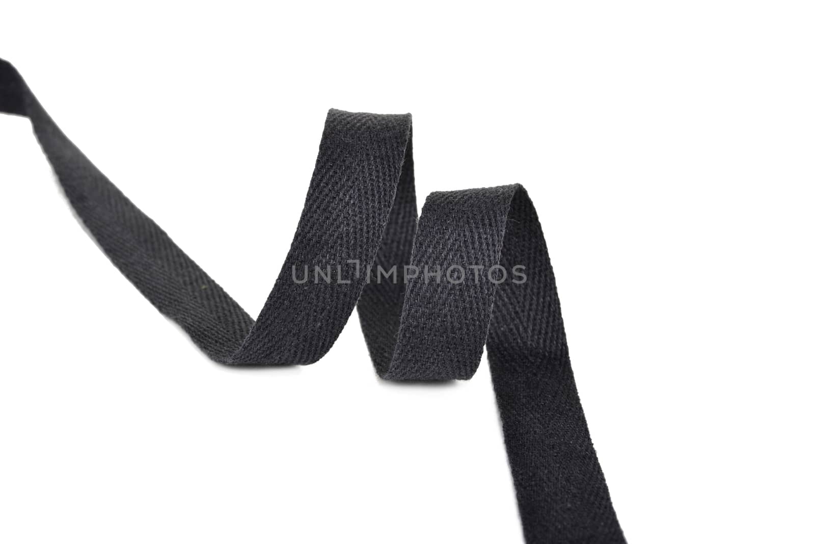 black Twisted ribbon of cotton Keeper braid on white background. Tape For sewing clothes.