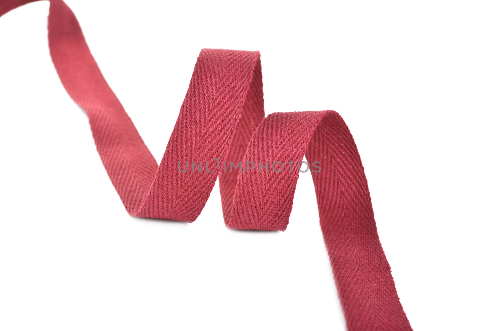 red Twisted ribbon of cotton Keeper braid on white background. Tape For sewing clothes.