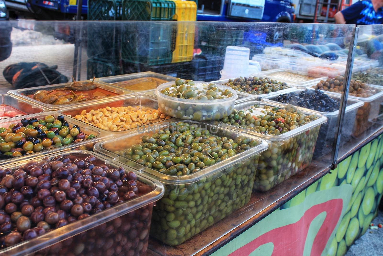 Olives and pickles at a market stall by soniabonet